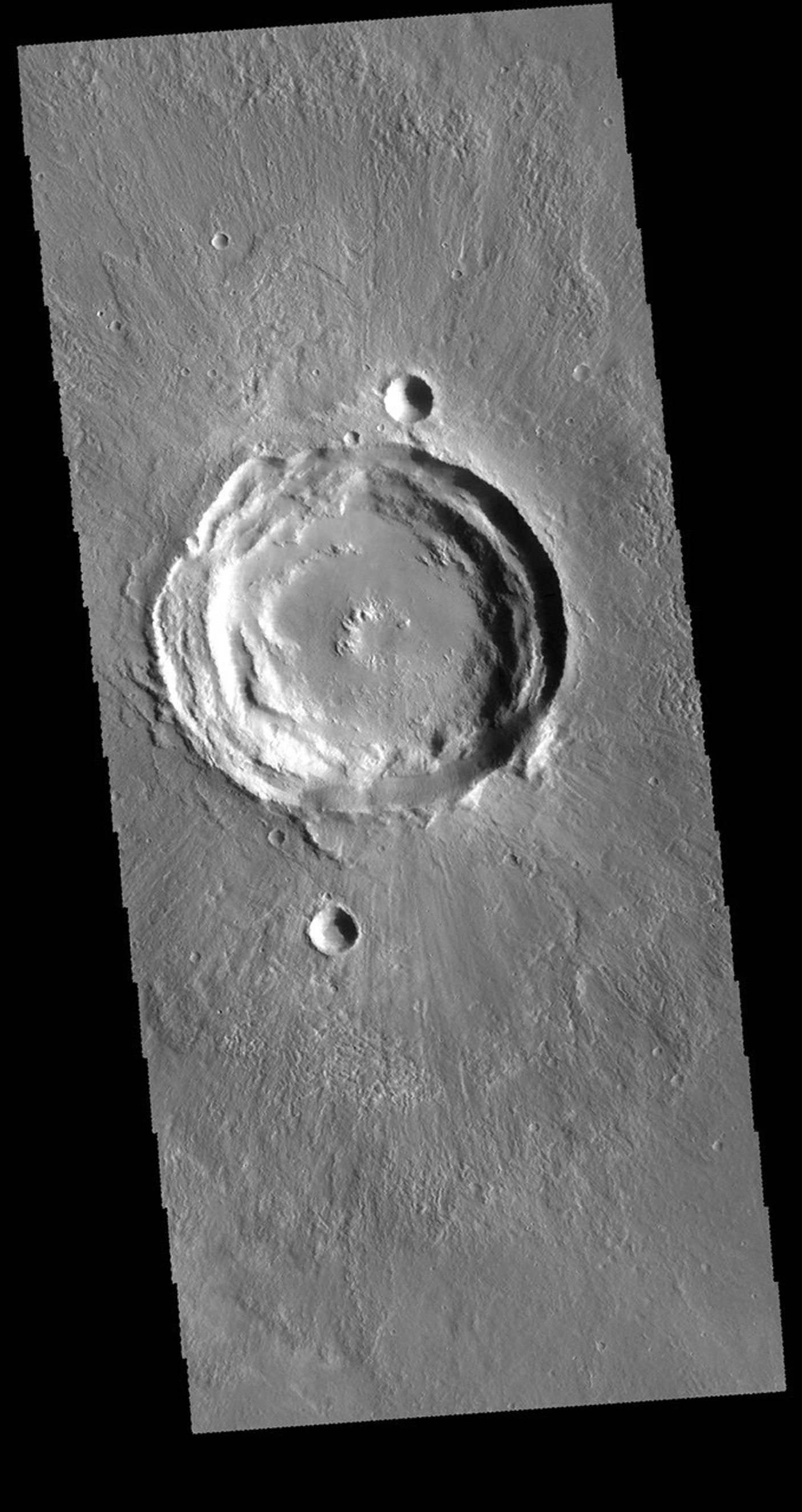 This image captured by NASA's 2001 Mars Odyssey spacecraft shows an unnamed crater near Acheron Fossae. The structure of this crater includes a central pit and several concentric rims.