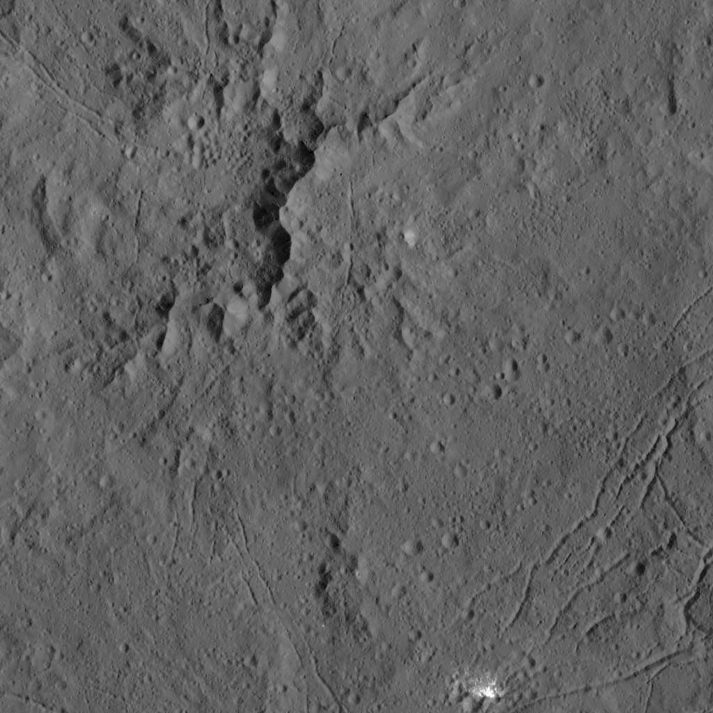 This view from NASA's captured by NASA's Dawn spacecraft on Dec. 21,2015, shows the central complex of mountain peaks within Dantu Crater on Ceres. A patch of bright material is visible near lower right.