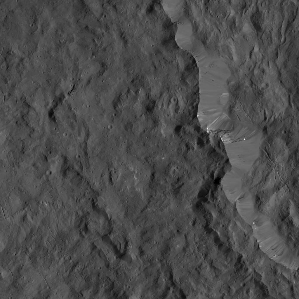 This image from NASA's Dawn spacecraft shows the western rim of Occator Crater. Several small, bright patches of material can be seen along the rim.
