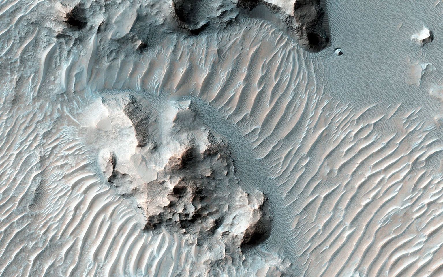 Schaeberle Crater is a large, heavily-infilled crater with many interesting features. This image NASA's Mars Reconnaissance Orbiter spacecraft shows a window into the crater fill deposit, showcasing eroding bedrock and aeolian landforms.