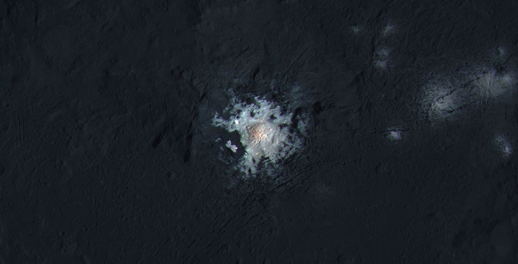 The bright central spots near the center of Occator Crater are shown in enhanced color in this view from NASA's Dawn spacecraft. Such views can be used to highlight subtle color differences on Ceres' surface.