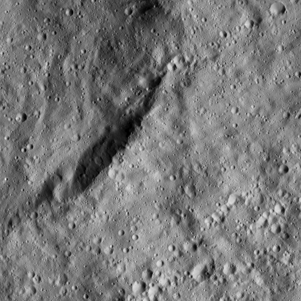 The view from NASA's Dawn spacecraft shows an unnamed crater that lies in the northeast part of the larger impact feature Gaue. The area is dominated by small craters and is relatively smooth in general.