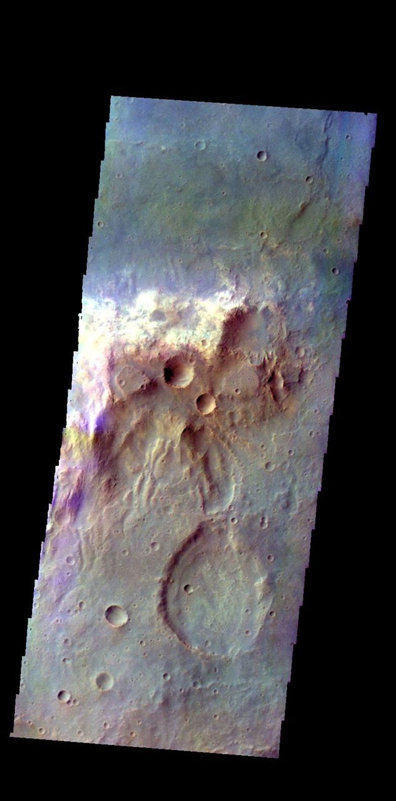 The THEMIS camera contains 5 filters. The data from different filters can be combined in multiple ways to create a false color image. This image from NASA's 2001 Mars Odyssey spacecraft shows a hill in Tyrrhena Terra.