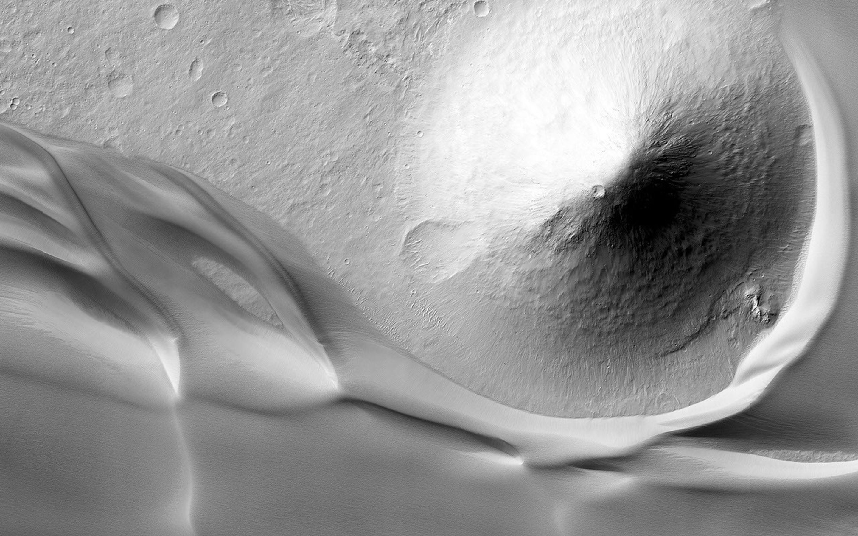 This image, acquired by NASA's Mars Reconnaissance Orbiter spacecraft, shows the eastern edge of a very large deposit of wind-blown dust that occupies Ganges Chasma.