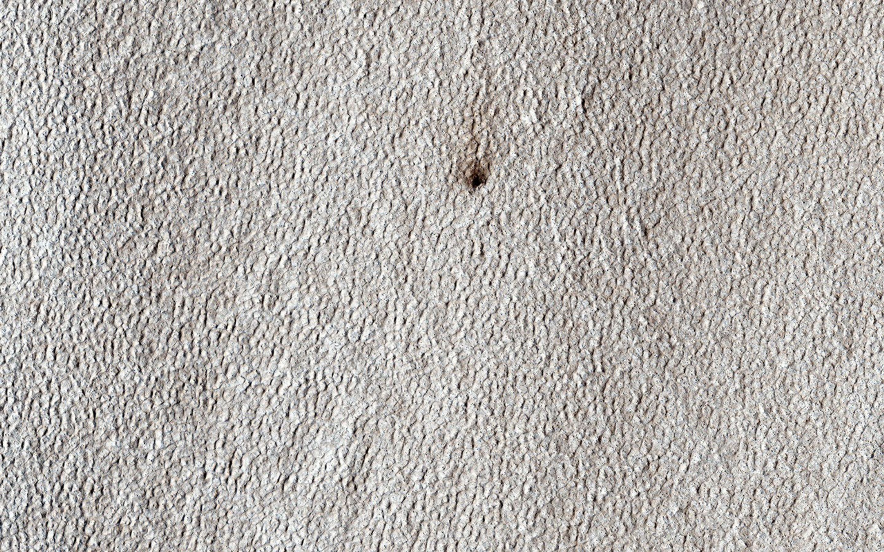 This image was targeted for NASA's Mars Reconnaissance Orbiter spacecraft to look at a candidate new crater on a lobate apron. Such aprons are often ice-rich, but the crater shows no bright material that would indicate ice.