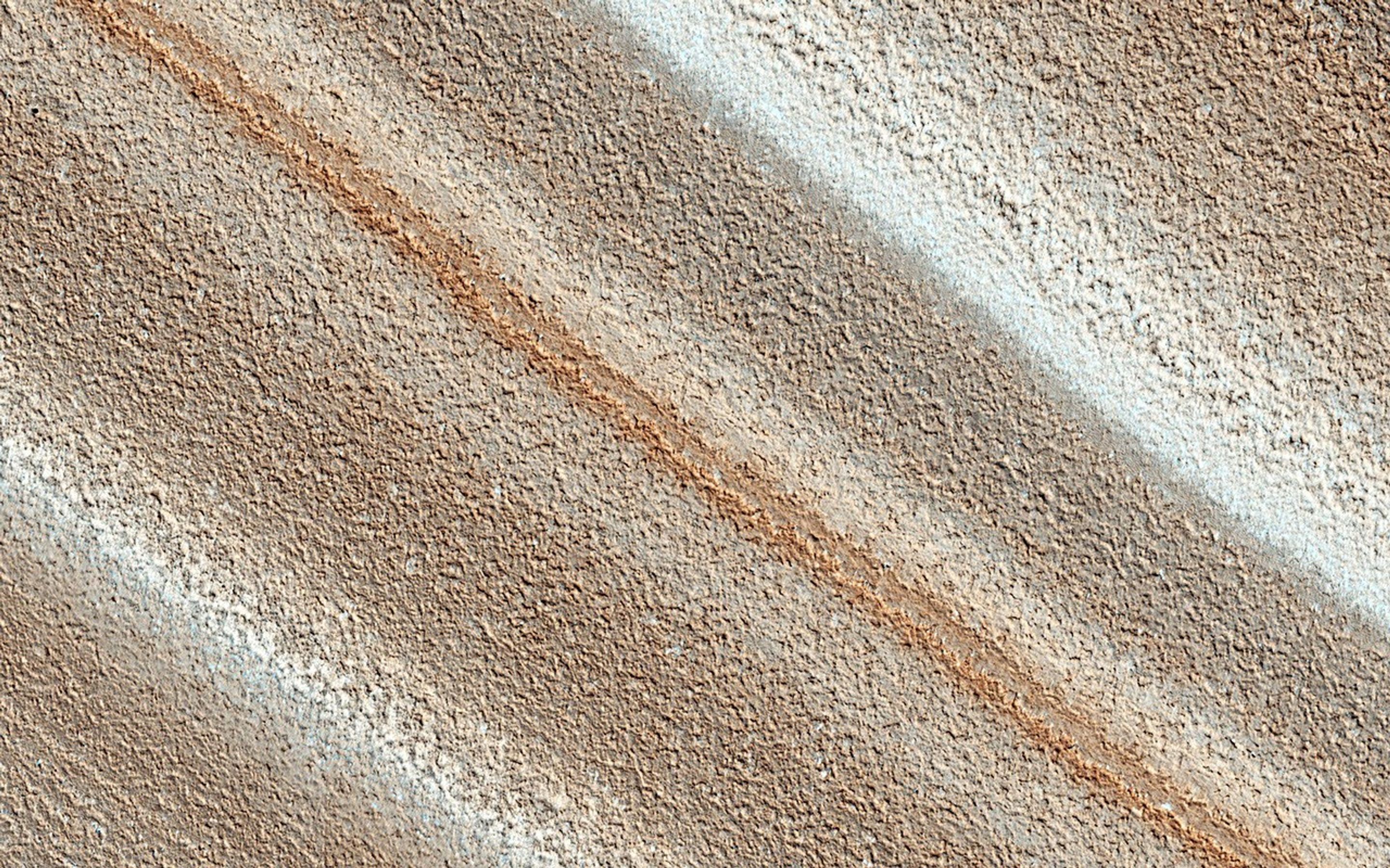 The North Polar layered deposits provide a record of recent climate changes on Mars as seen by NASA's Mars Reconnaissance Orbiter spacecraft. Color variations between layers are due to differences in composition of the dust.