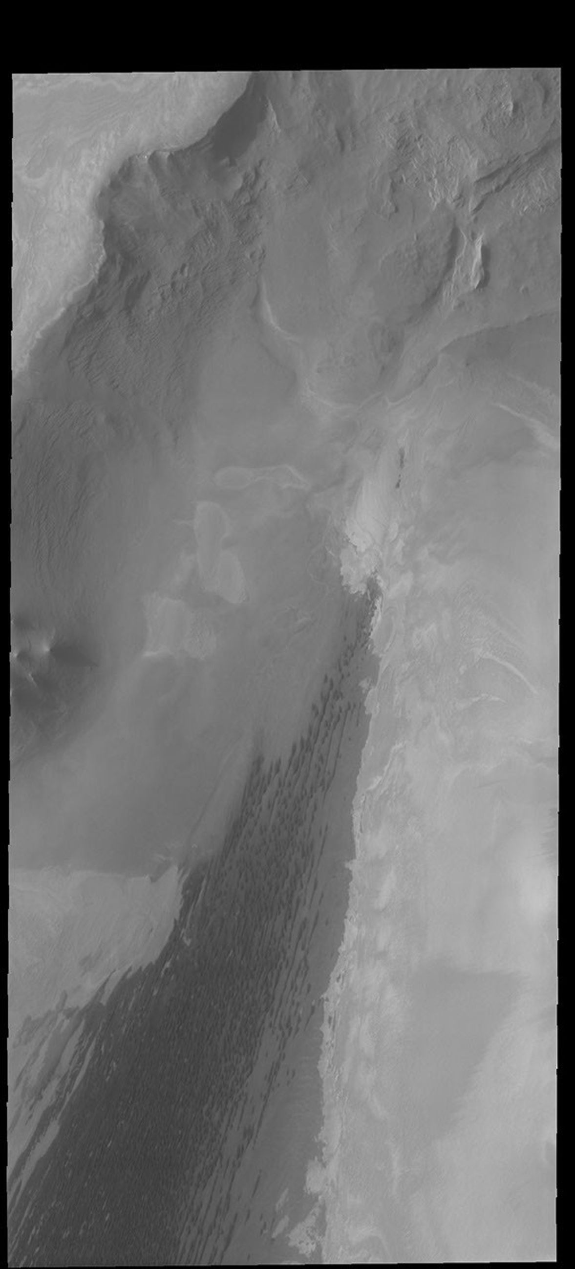 This image captured by NASA's 2001 Mars Odyssey spacecraft shows the north polar scarp, with the polar cap in the upper left corner.