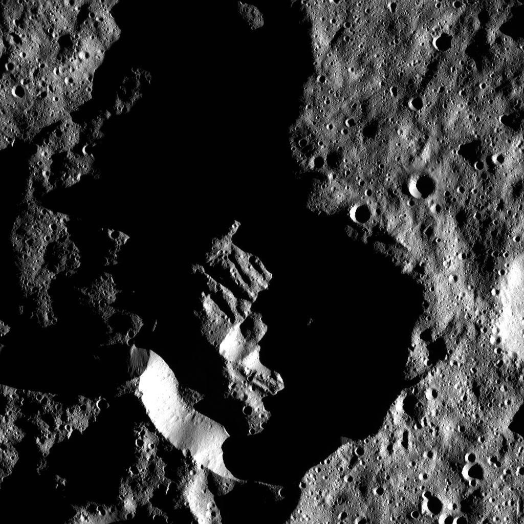 This image from NASA's Dawn spacecraft shows Attis Crater on Ceres, which measures 14 miles (22 kilometers) in diameter. The long shadows in and around the crater reflect Attis's far-southern location.