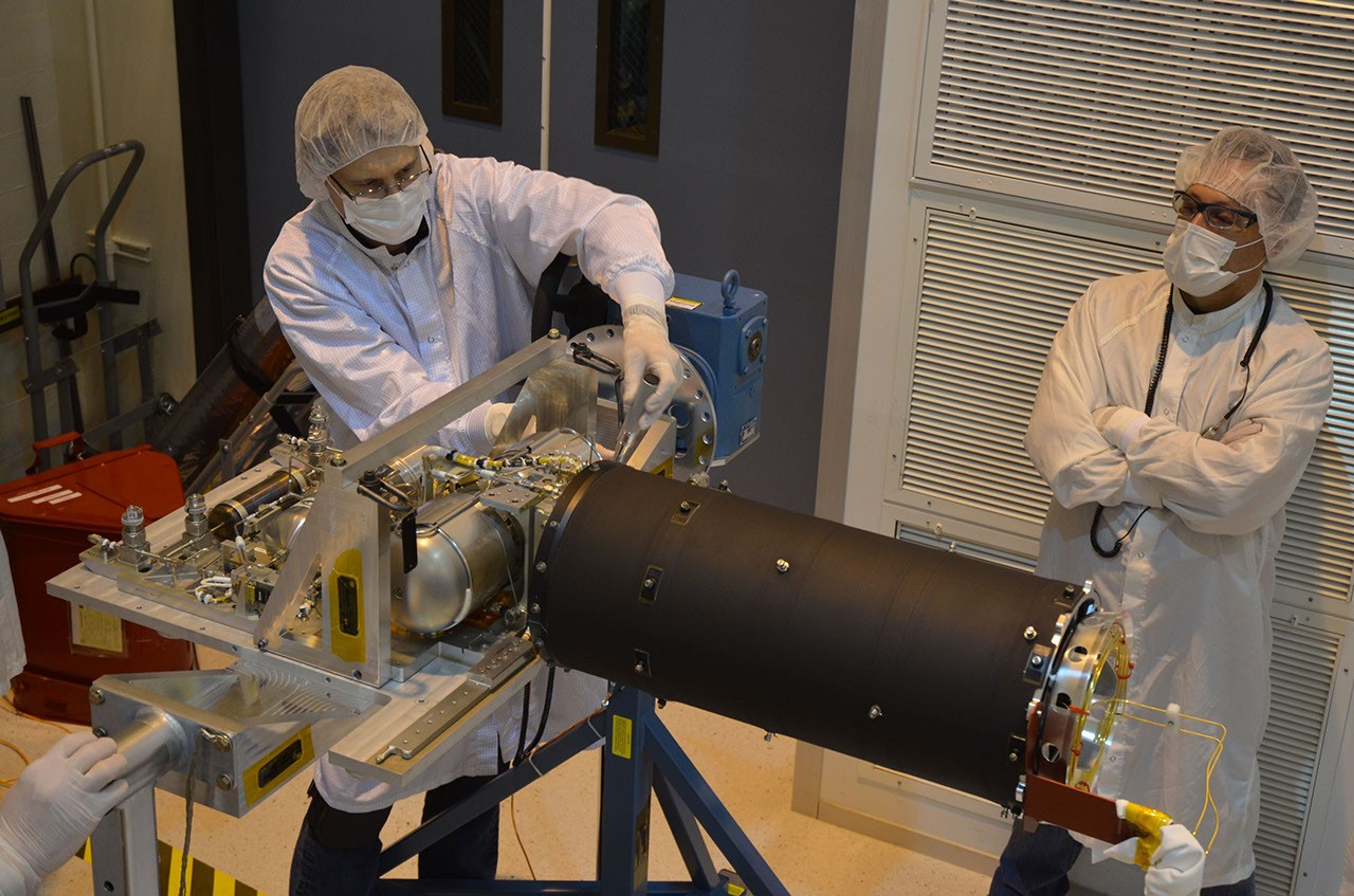 Technicians inspect the cooler for the Mid-Infrared Instrument, or MIRI, part of NASA's James Webb Space Telescope.