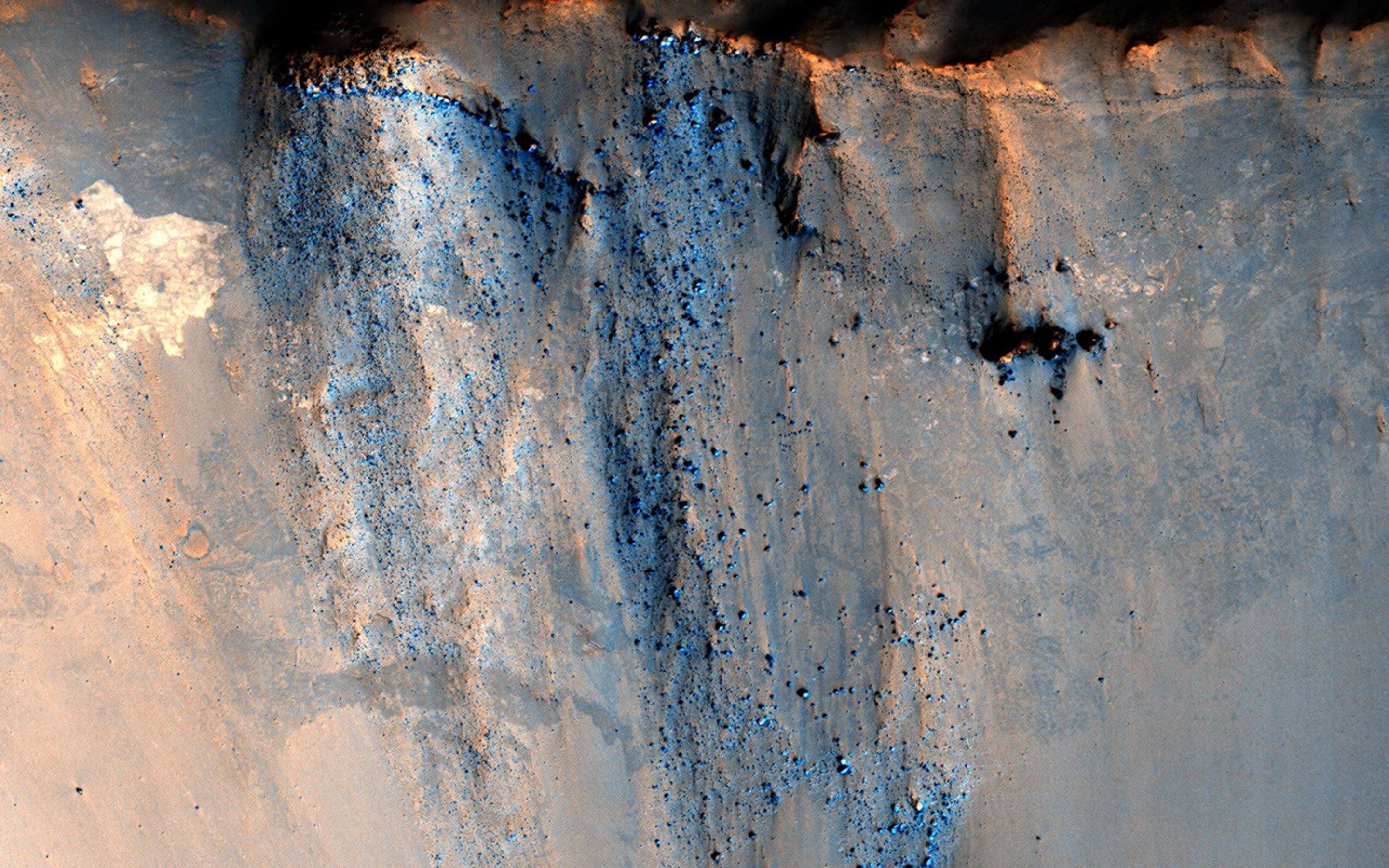 This image captured by NASA's Mars Reconnaissance Orbiter spacecraft targets a 3-kilometer diameter crater that occurs within the ejecta blanket of the much older Bakhuysen Crater, a 150-kilometer diameter impact crater in Noachis Terra.