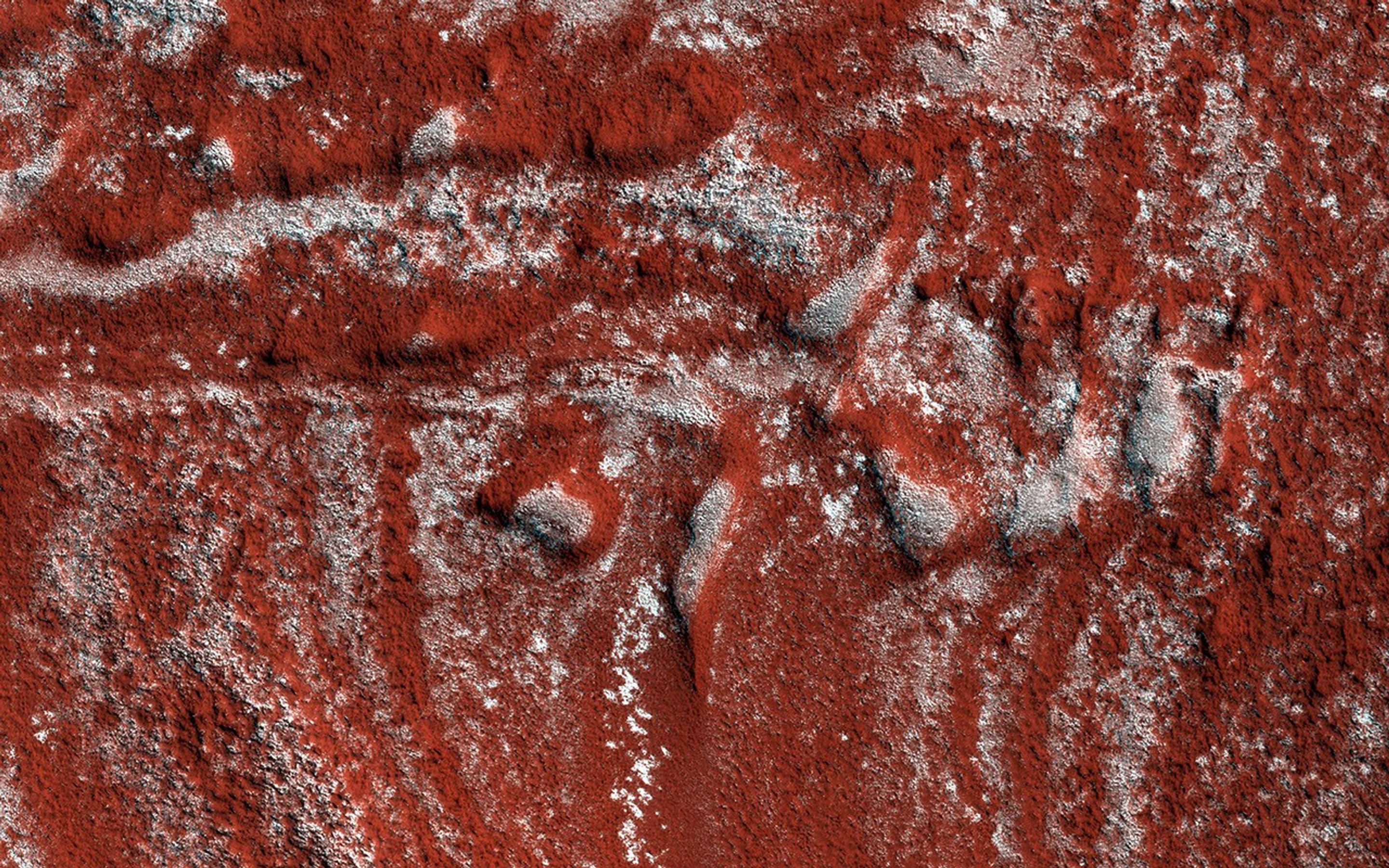 These North Polar layered deposits, composed of ice, captured by NASA's Mars Reconnaissance Orbiter spacecraft, show what looks like drag folds, where rock layers bend (fold) before they break in a fault.