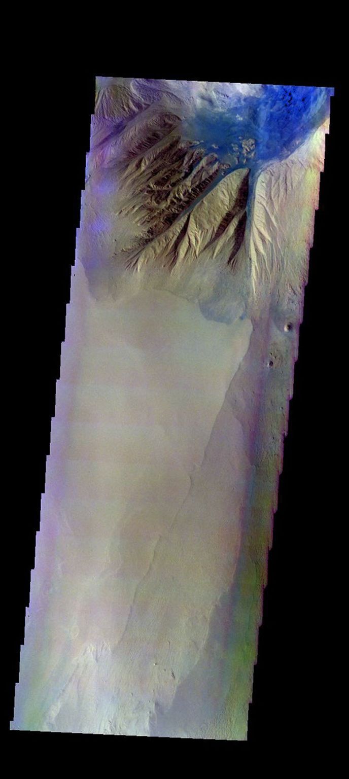 The THEMIS camera contains 5 filters. The data from different filters can be combined in multiple ways to create a false color image. This image from NASA's 2001 Mars Odyssey spacecraft shows the northern tip of Baetis Mensa.
