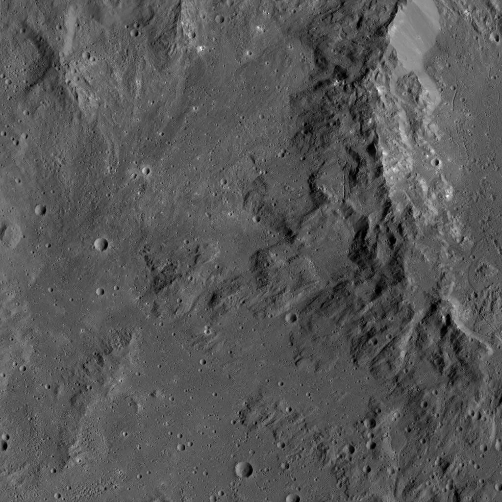 Smooth terrain around the western rim of Ikapati Crater on Ceres is visible in this image from NASA's Dawn spacecraft. The area contains material ejected from Ikapati during its formation.