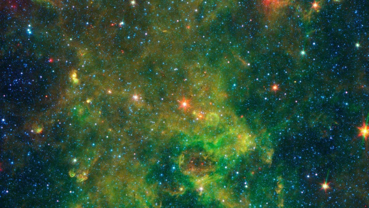 An age-defying star called IRAS 19312+1950 stands out as extremely bright inside a large, chemically rich cloud of material, as shown in this image from NASA's Spitzer Space Telescope.