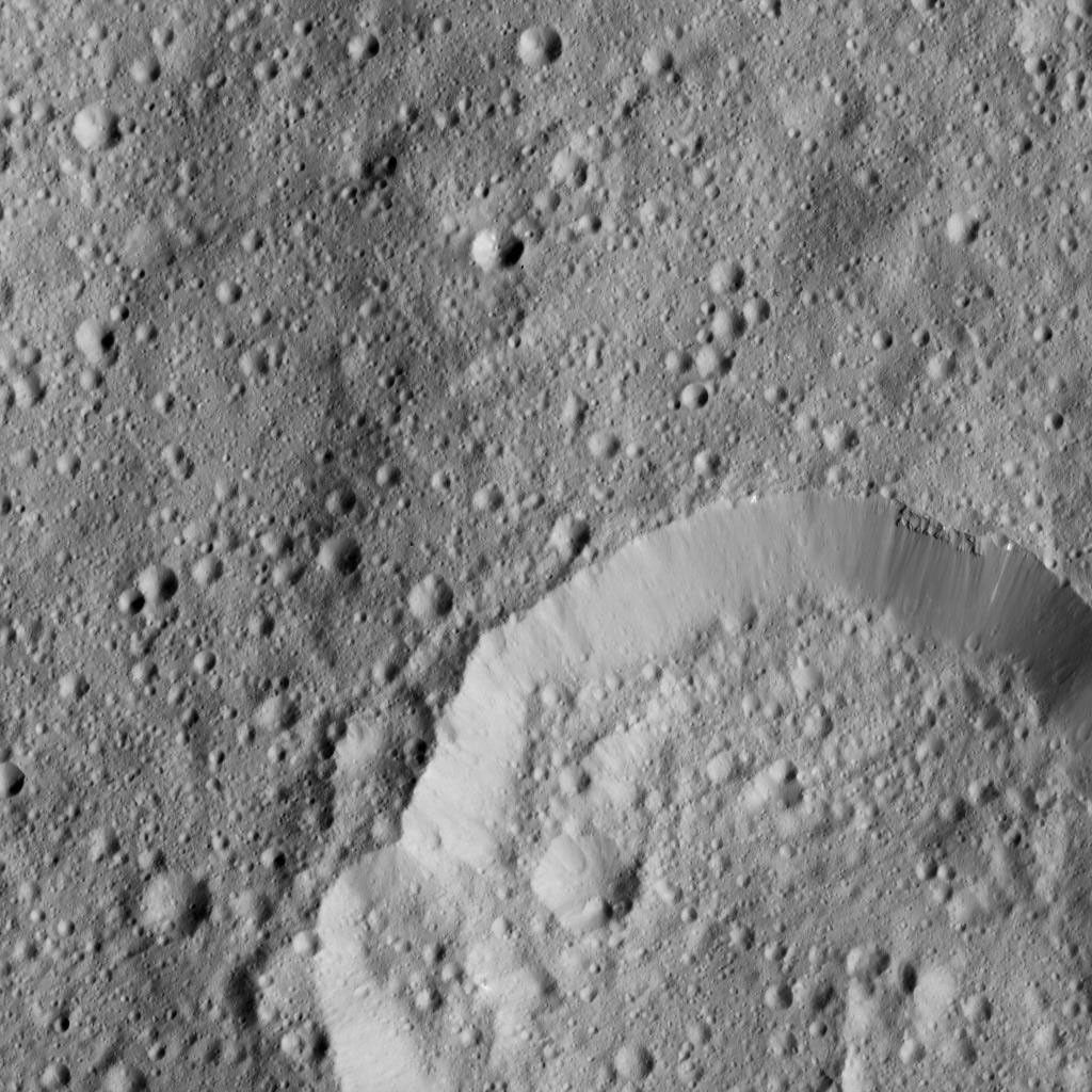 This image from NASA's Dawn spacecraft, taken on June 6, 2016, shows Piuku Crater (19 miles, 31 kilometers wide), bottom, on Ceres.