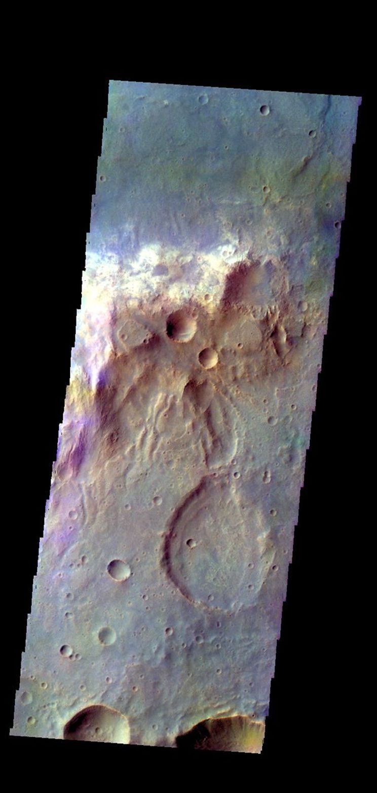 The THEMIS camera contains 5 filters. The data from different filters can be combined in multiple ways to create a false color image. This image from NASA's 2001 Mars Odyssey spacecraft shows part of the plains of Tyrrhena Terra.