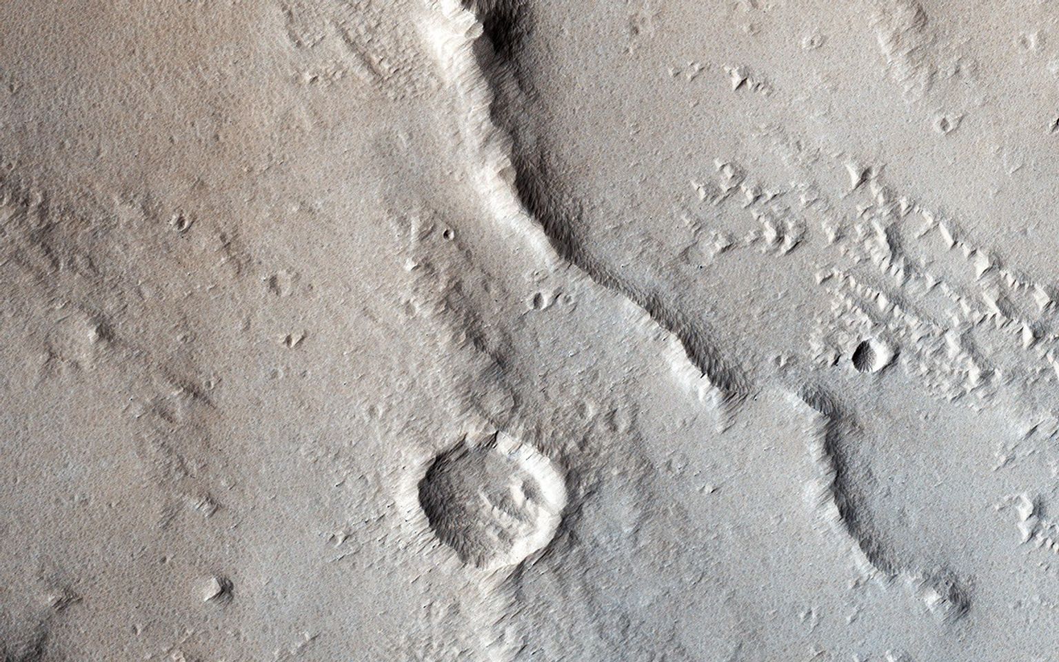 In this image from NASA's Mars Reconnaissance Orbiter tectonic stresses highly modified this area of Ganges Catena, north of Valles Marineris.