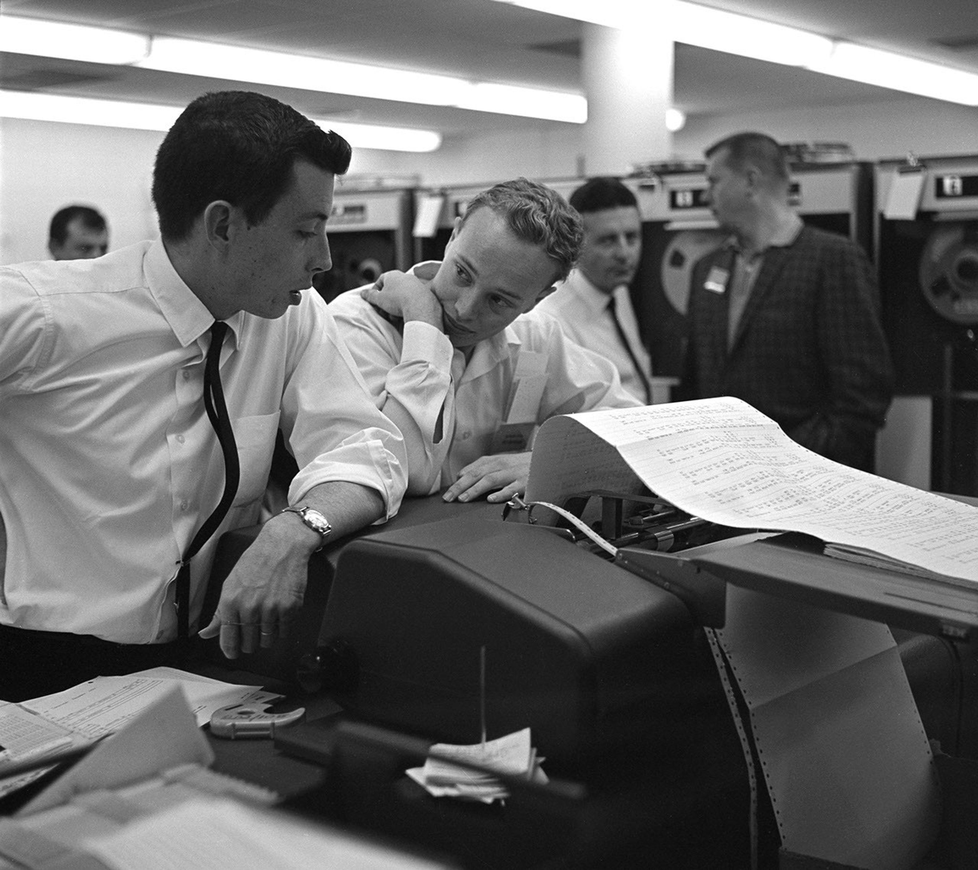 This archival image shows engineers at NASA's Jet Propulsion Laboratory looking at data related to the Venus flyby of Mariner 2 on Dec. 14, 1962. This was the first successful flyby of another planet.
