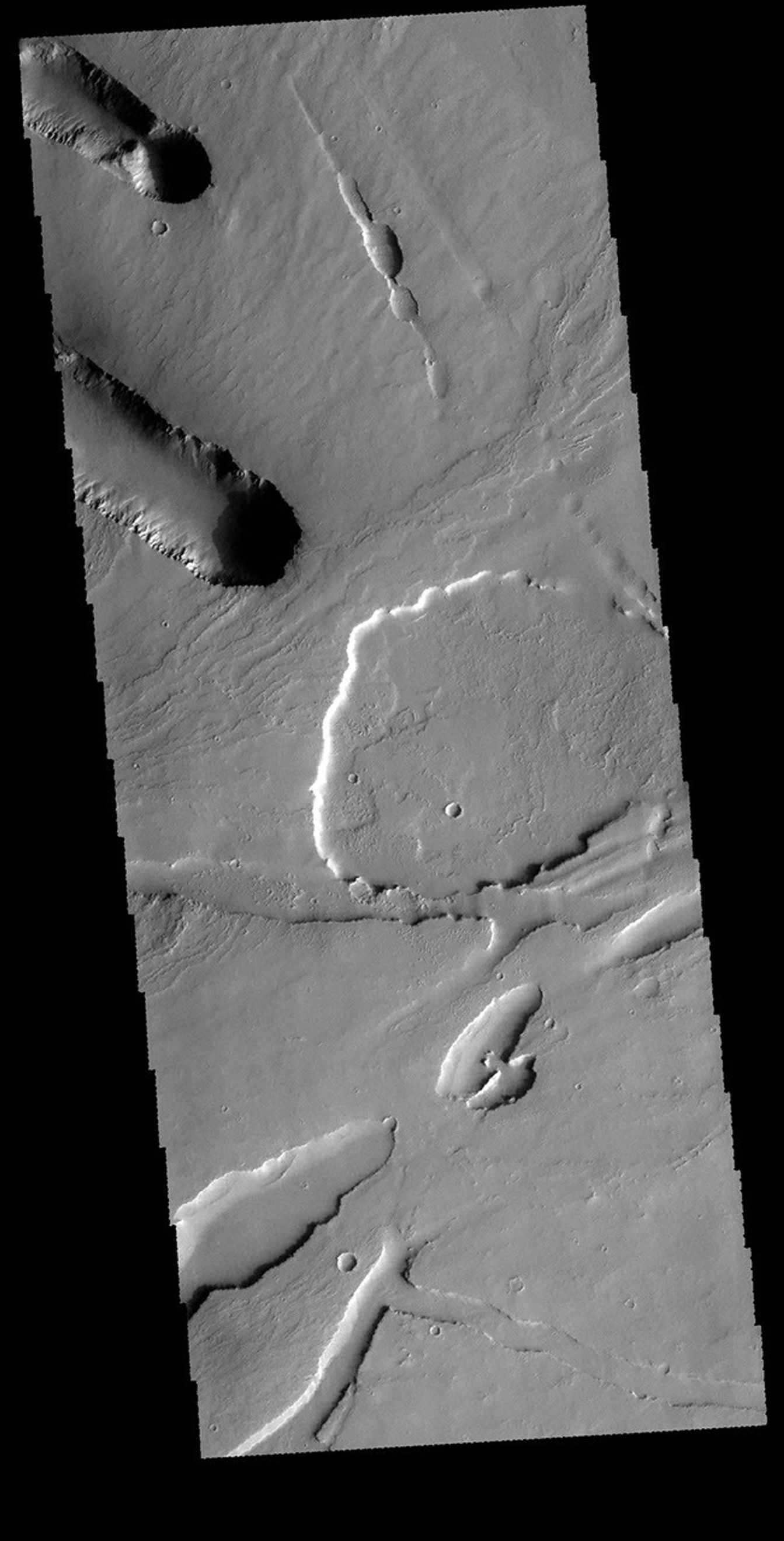 This image captured by NASA's 2001 Mars Odyssey spacecraft shows part of the area where Pavonis Chasma intersects with Pavonis Fossae.
