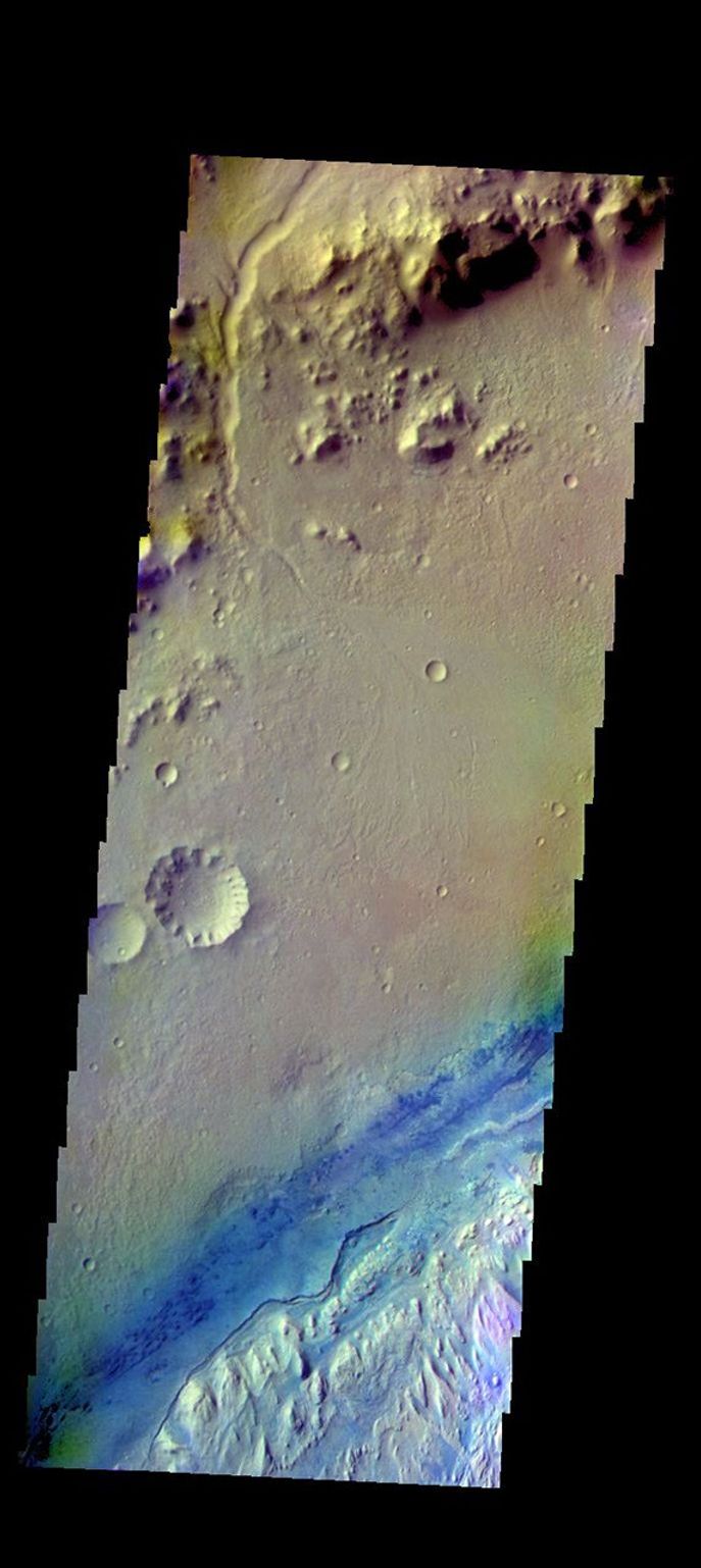 The THEMIS camera contains 5 filters. The data from different filters can be combined in multiple ways to create a false color image. This image from NASA's 2001 Mars Odyssey spacecraft shows part of Gale Crater.