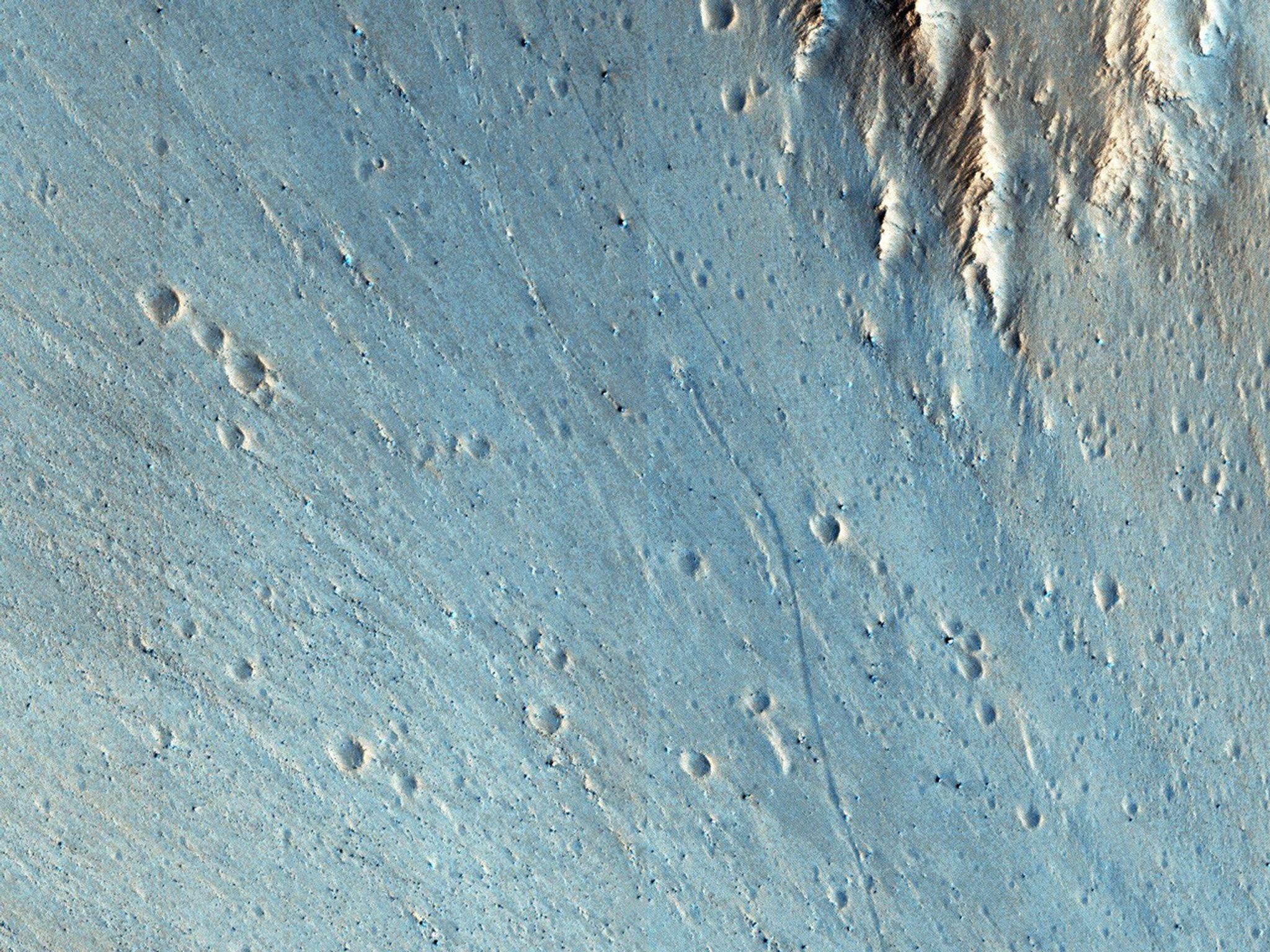 This picture of the rim of Eos Chasma in Valles Marineris, captured by NASA's Mars Reconnaissance Orbiter, shows active erosion of the Martian surface.