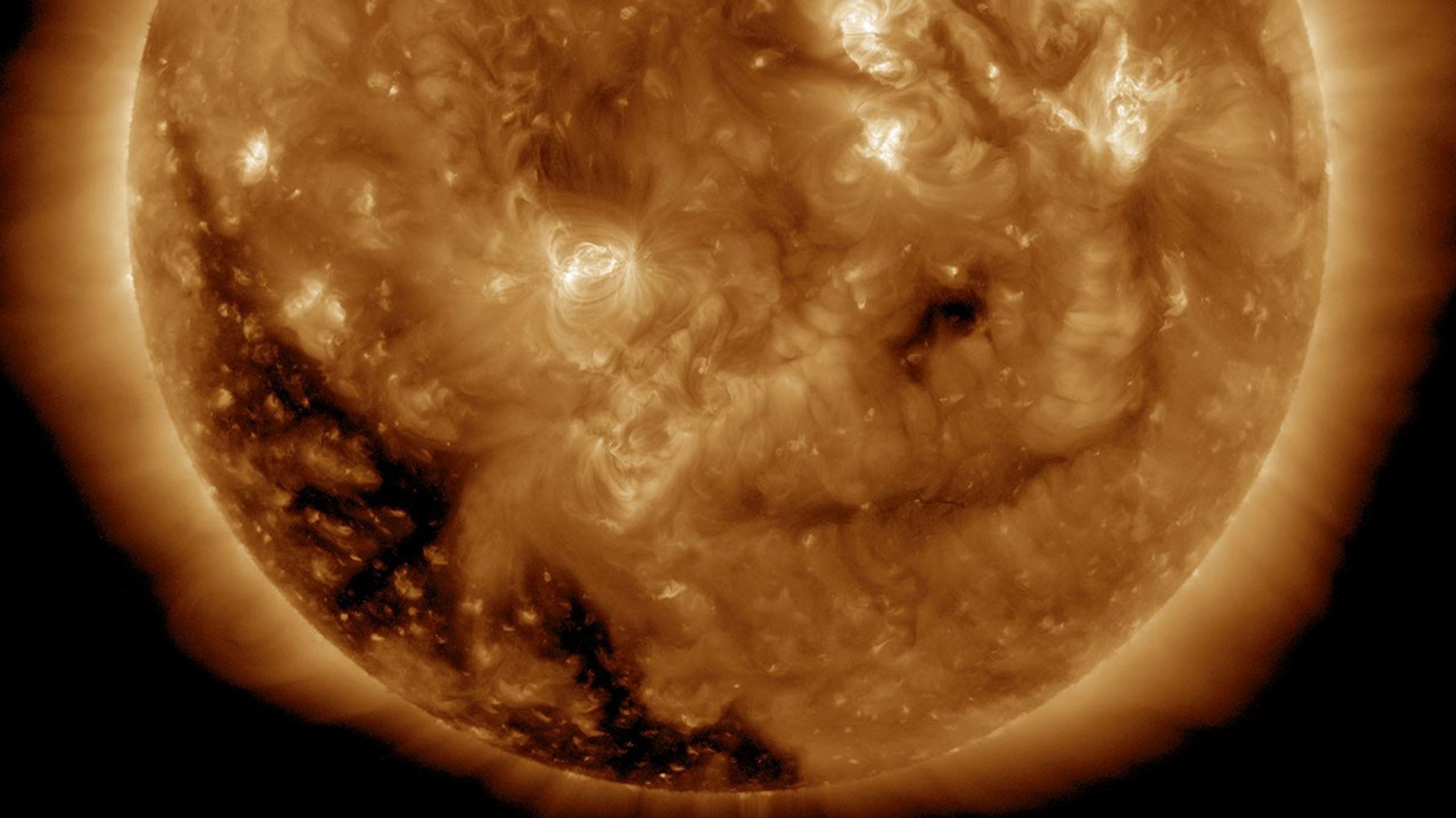 NASA's Solar Dynamics Observatory spied a substantial coronal hole begin to rotate into view over Dec. 1-2, 2016. Coronal holes are magnetically open areas of the sun's magnetic field structure that spew streams of high speed solar wind into space.