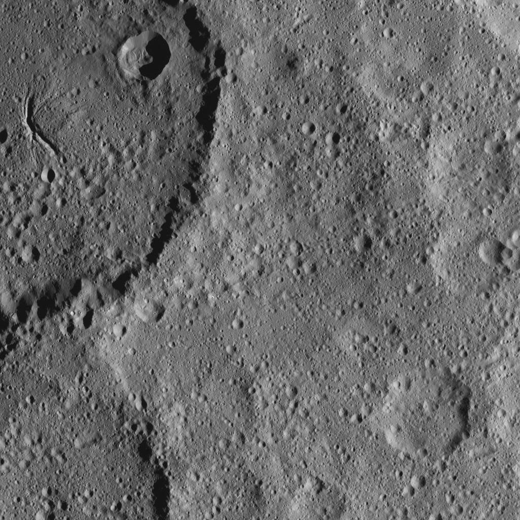 Part of Ezinu Crater on Ceres is seen at top left in this image from NASA's Dawn spacecraft taken on Oct. 20, 2016. The crater features a network of canyon-like features.