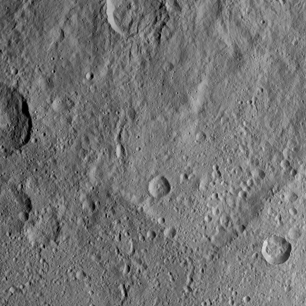 This scene viewed by NASA's Dawn spacecraft on Oct. 20, 2016, from Ceres features terrain near the rim of the large crater named Kerwan, at lower left. A much smaller, fresher crater called Cacaguat is seen in the lower right corner.
