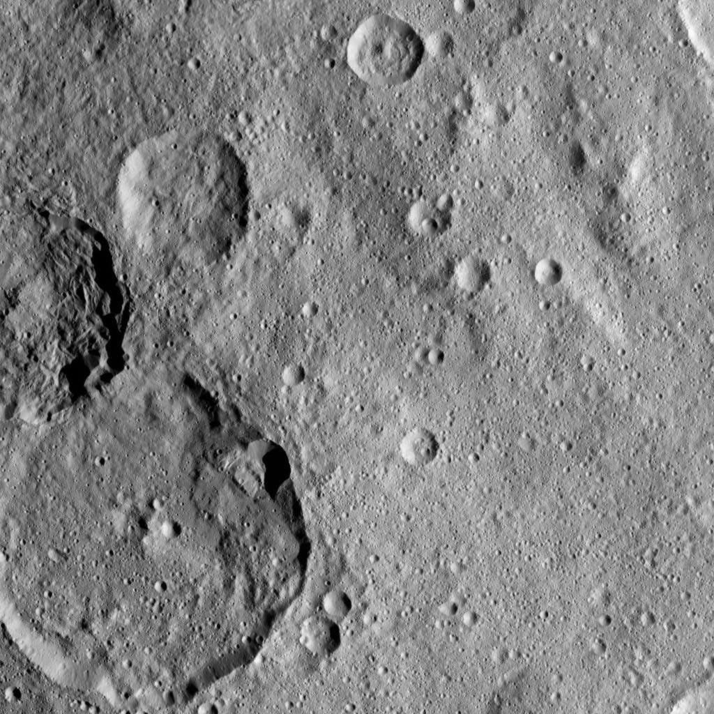 This view, taken on Oct. 22, 2016, from NASA's Dawn spacecraft shows the craters Kondos and Jarimba on Ceres. Jarimba is the largest crater, located at left. Above Jarimba, on the left-hand edge of the image, is Kondos.