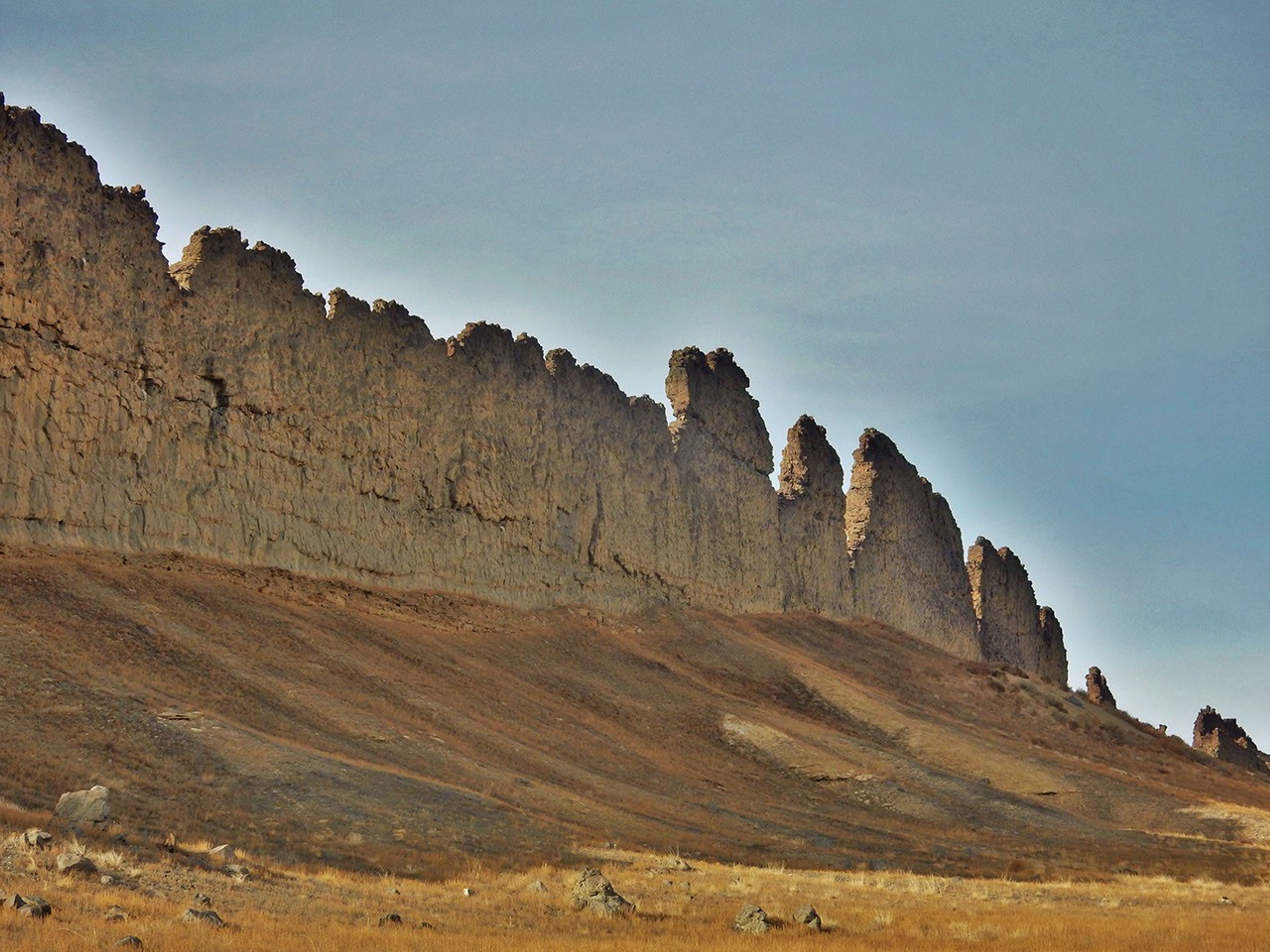 This photograph from northwestern New Mexico shows a ridge roughly 30 feet (about 10 meters) tall that formed from lava filling an underground fracture then resisting erosion better than the material around it did.