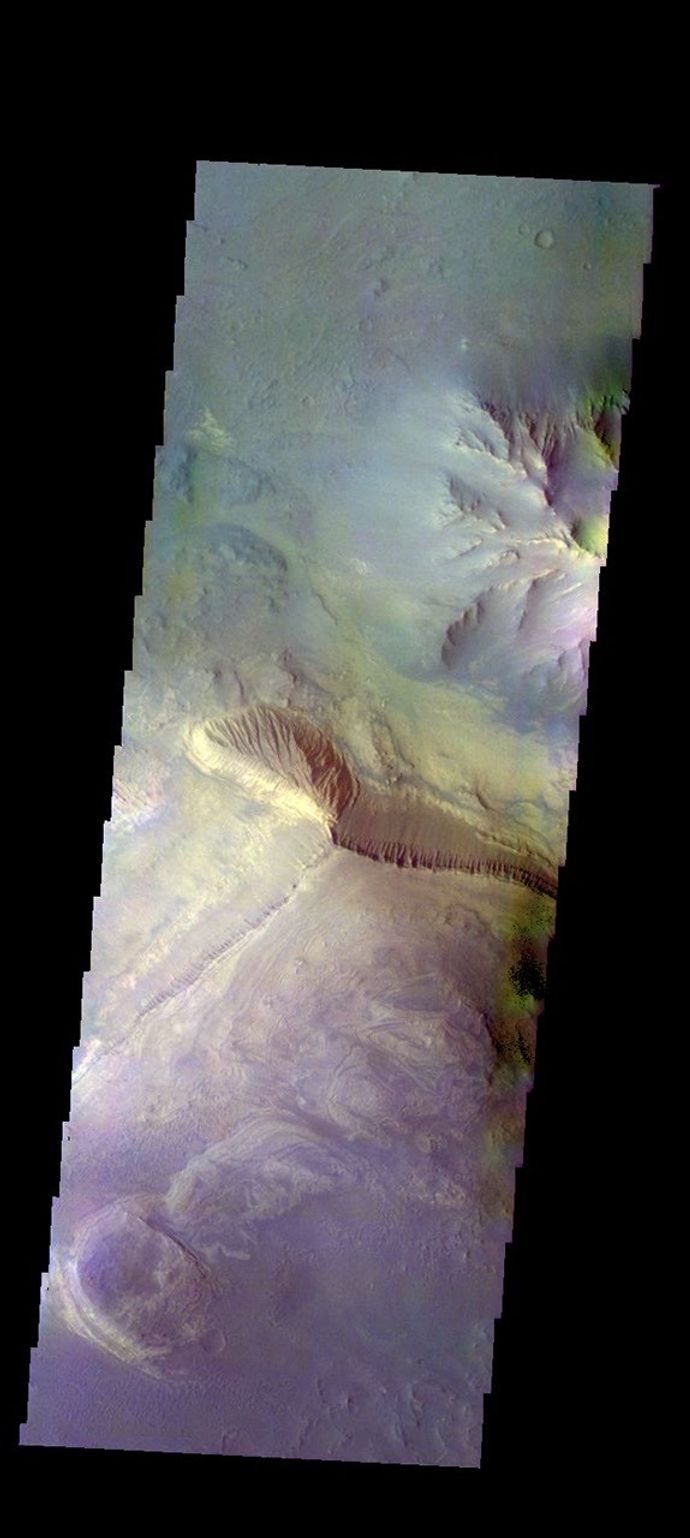 The THEMIS camera contains 5 filters. The data from different filters can be combined in multiple ways to create a false color image. This image from NASA's 2001 Mars Odyssey spacecraft shows part of the interior of Coprates Chasma.