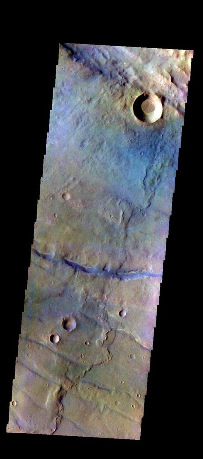 The THEMIS camera contains 5 filters. The data from different filters can be combined in multiple ways to create a false color image. This image from NASA's 2001 Mars Odyssey spacecraft shows part of the plains of Thaumasia Planum.