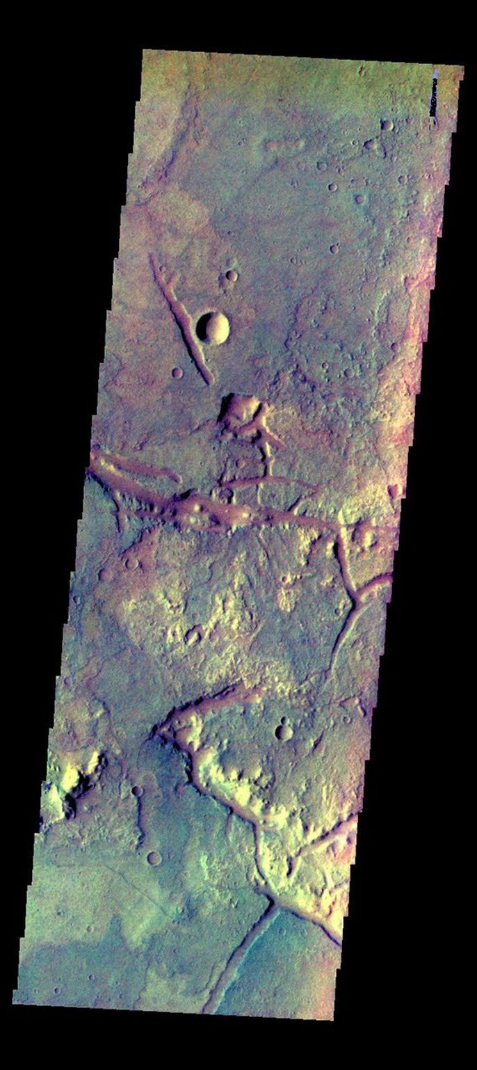The THEMIS camera contains 5 filters. The data from different filters can be combined in multiple ways to create a false color image. This image from NASA's 2001 Mars Odyssey spacecraft shows some of the plains of Margaritifer Terra.
