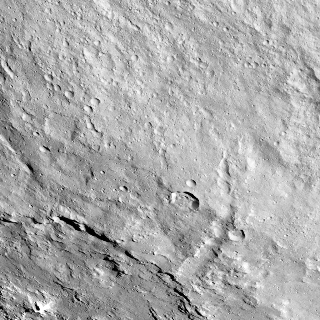 This image from NASA's Dawn spacecraft shows the northeastern rim of Urvara Crater on Ceres at lower left. To the right of the crater, the long, narrow feature that appears to jut out toward the north is called Pongal Catena.