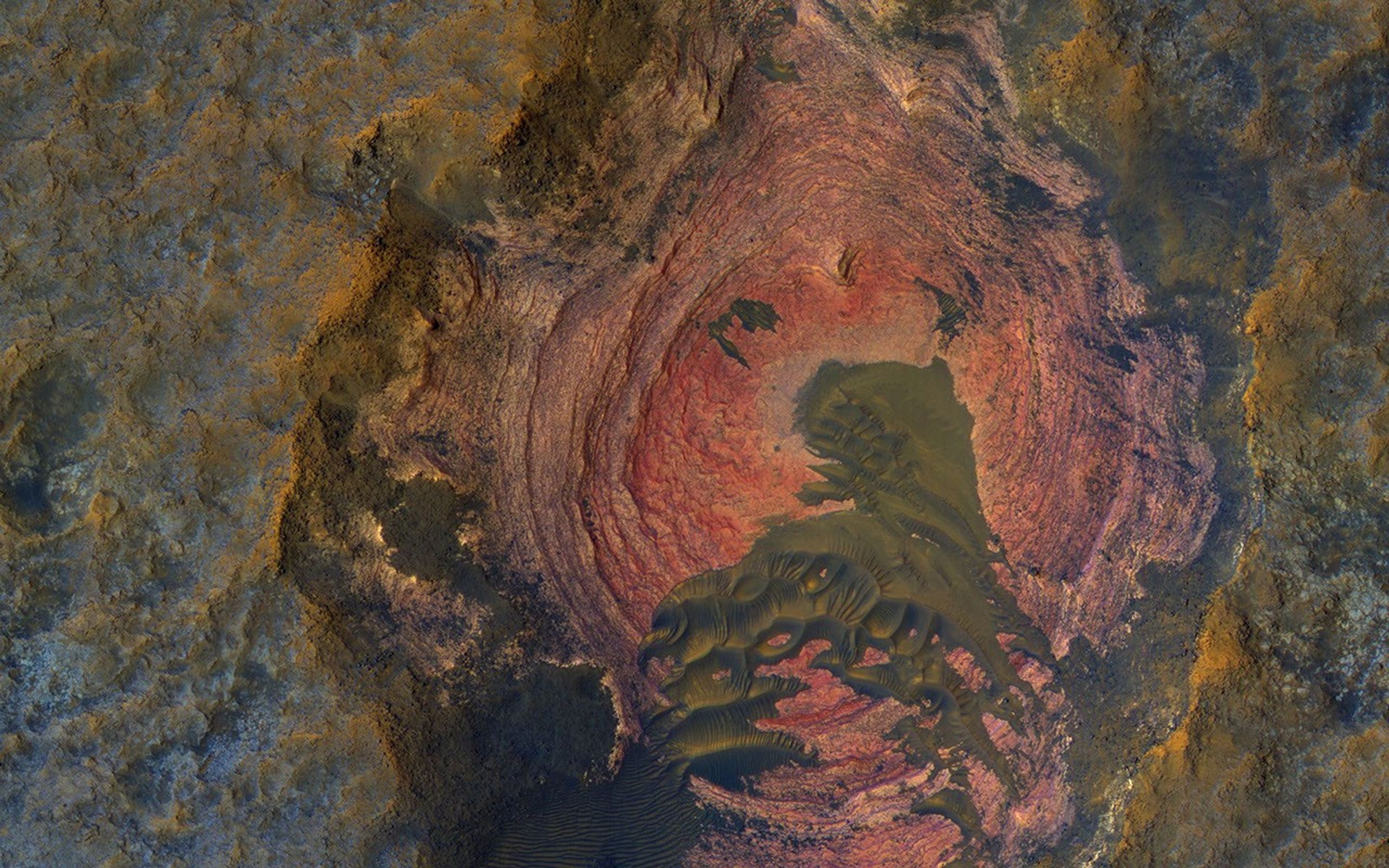 Much of Mars' surface is covered by fine-grained materials that hide the bedrock, but in this scene from NASA's Mars Reconnaissance Orbiter, the bedrock is well exposed except where covered by sand dunes.