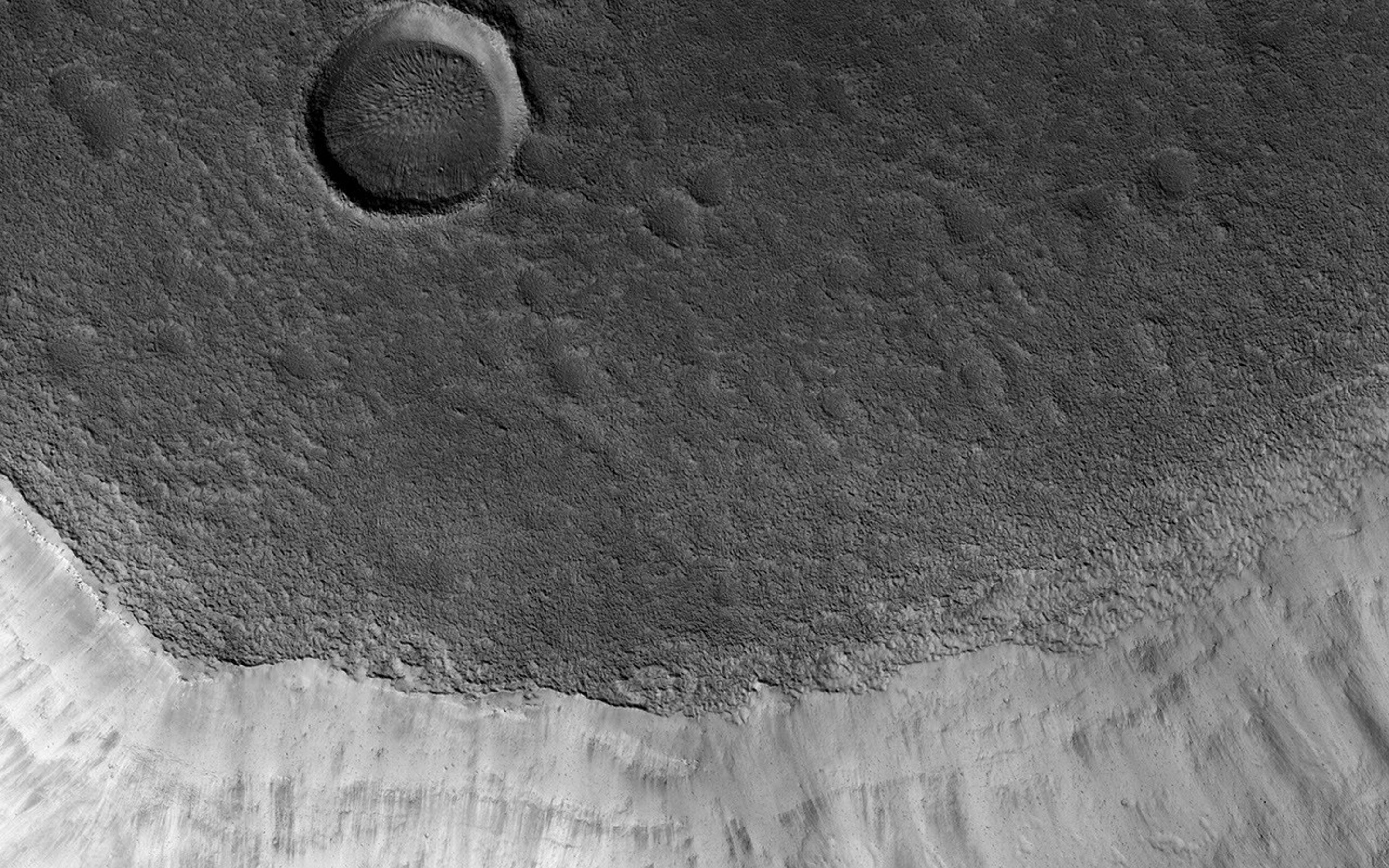 Mamers Valles is a long sinuous canyon beginning in Arabia Terra and ending in the Northern lowlands of Deuteronilus Mensae. This image from NASA's Mars Reconnaissance Orbiter features the southern facing slope of the canyon wall.