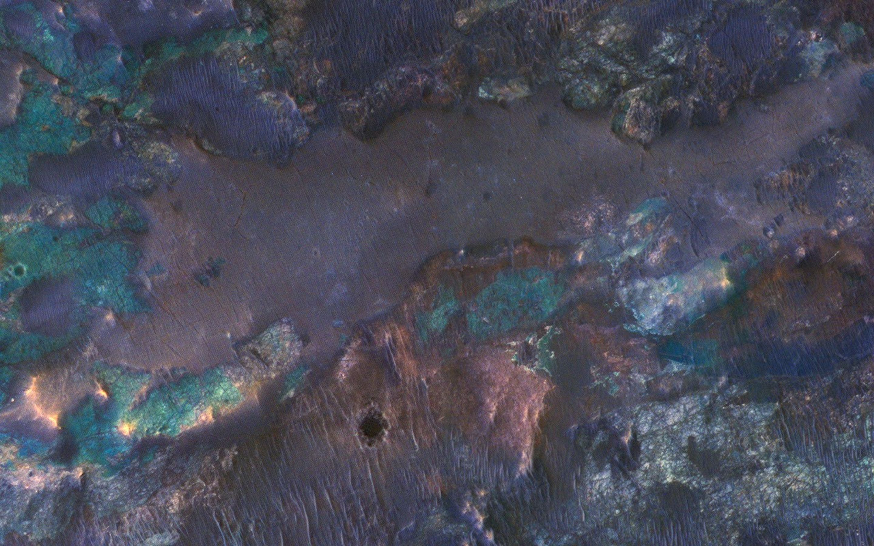 The collision that created Hargraves Crater impacted into diverse bedrock lithologies of ancient Mars; the impact ejecta is a rich mix of rock types with different colors and textures, as seen by NASA's Mars Reconnaissance Orbiter.