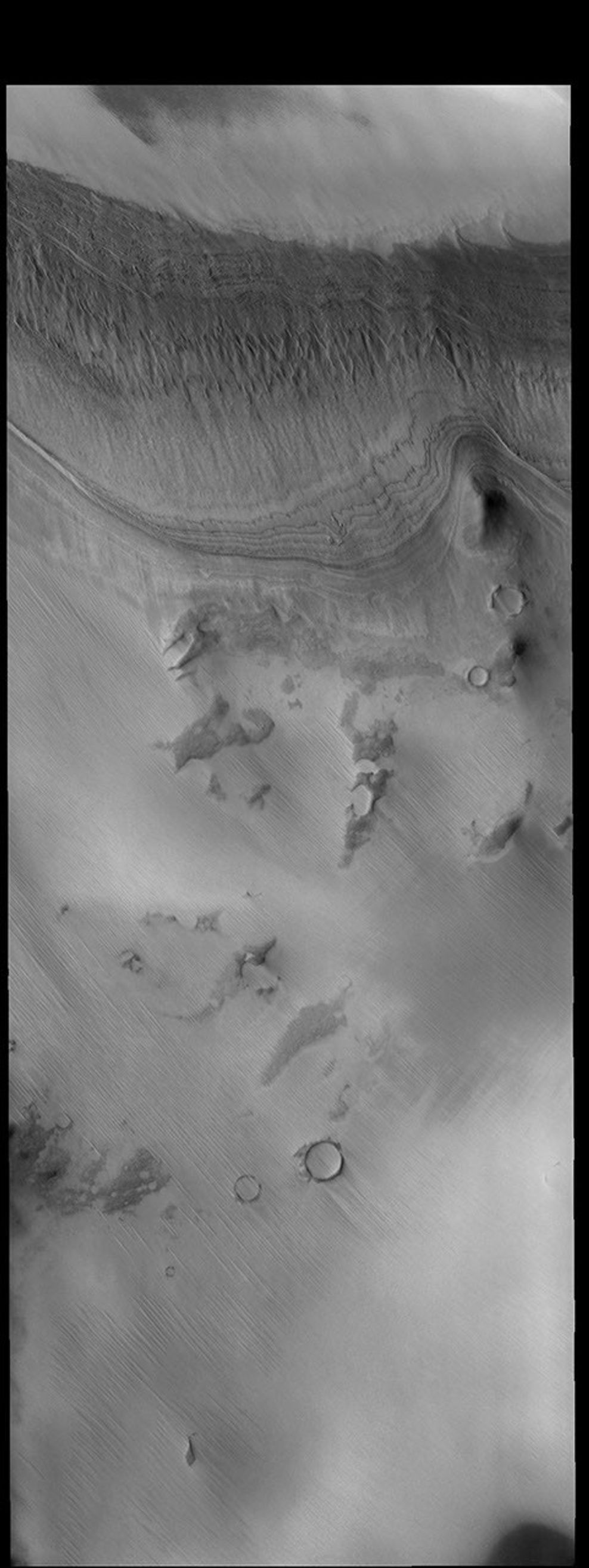 This image captured by NASA's 2001 Mars Odyssey spacecraft shows layered materials just off the south polar cap.