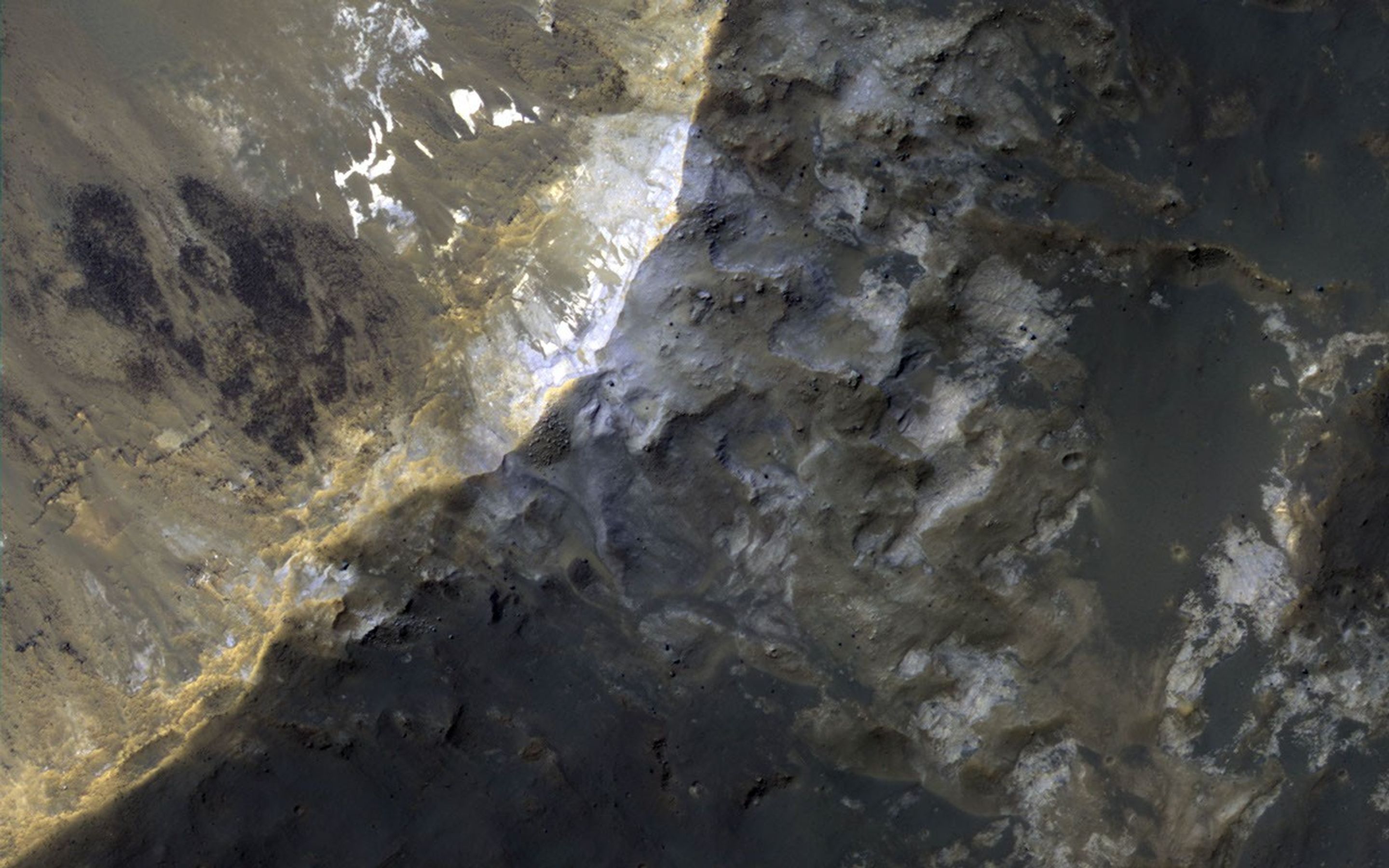 NASA's Mars Reconnaissance Orbiter observes an impact crater with associated bright deposits that at first glance give the appearance of seasonal frost or ice accumulations.