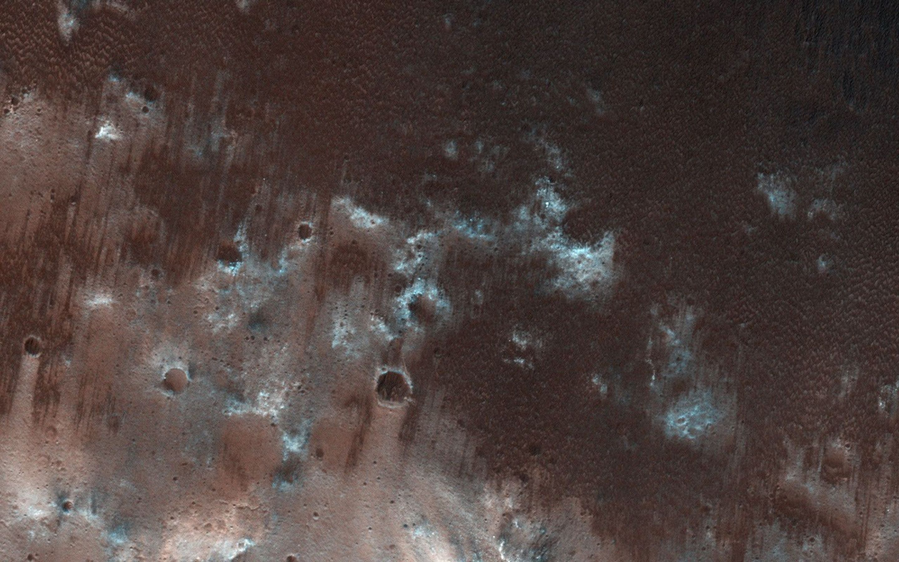 This view from NASA's Mars Reconnaissance Orbiter shows the downwind stretches of a sand sheet in central part of the much larger Herschel Crater.