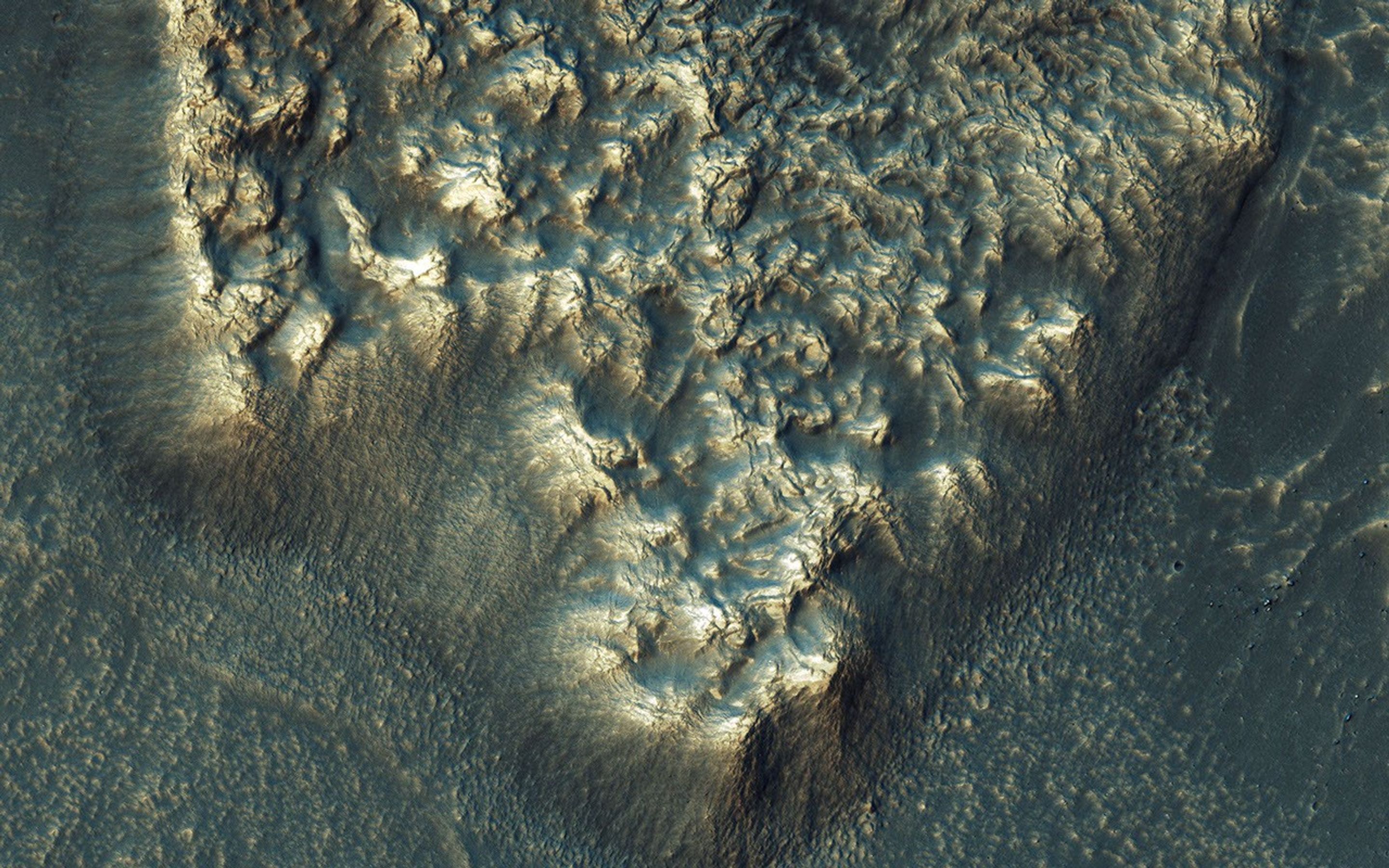 NASA's Mars Reconnaissance Orbiter observes many slopes in the middle latitudes of Mars showing icy flows or glaciers. The region shown here, in the south-facing slope of a crater. This region is unusual because the flows have bright highlights.