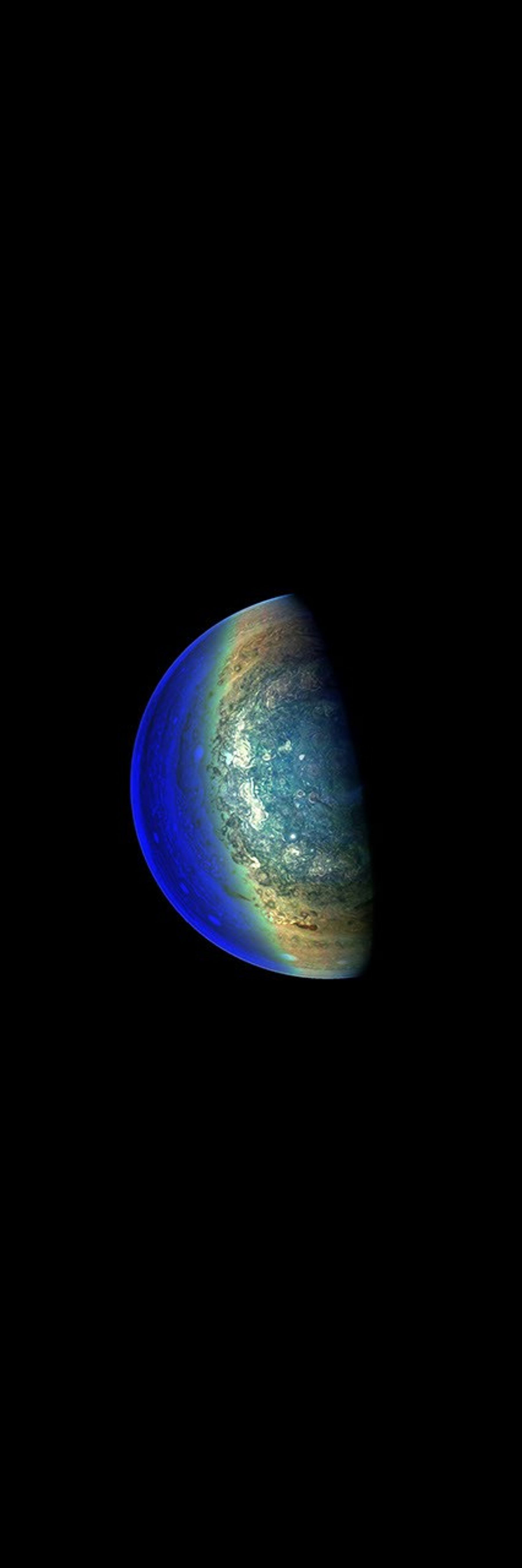 This image from NASA's Juno spacecraft captures the swirling cloud formations around the south pole of Jupiter, looking up toward the equatorial region.