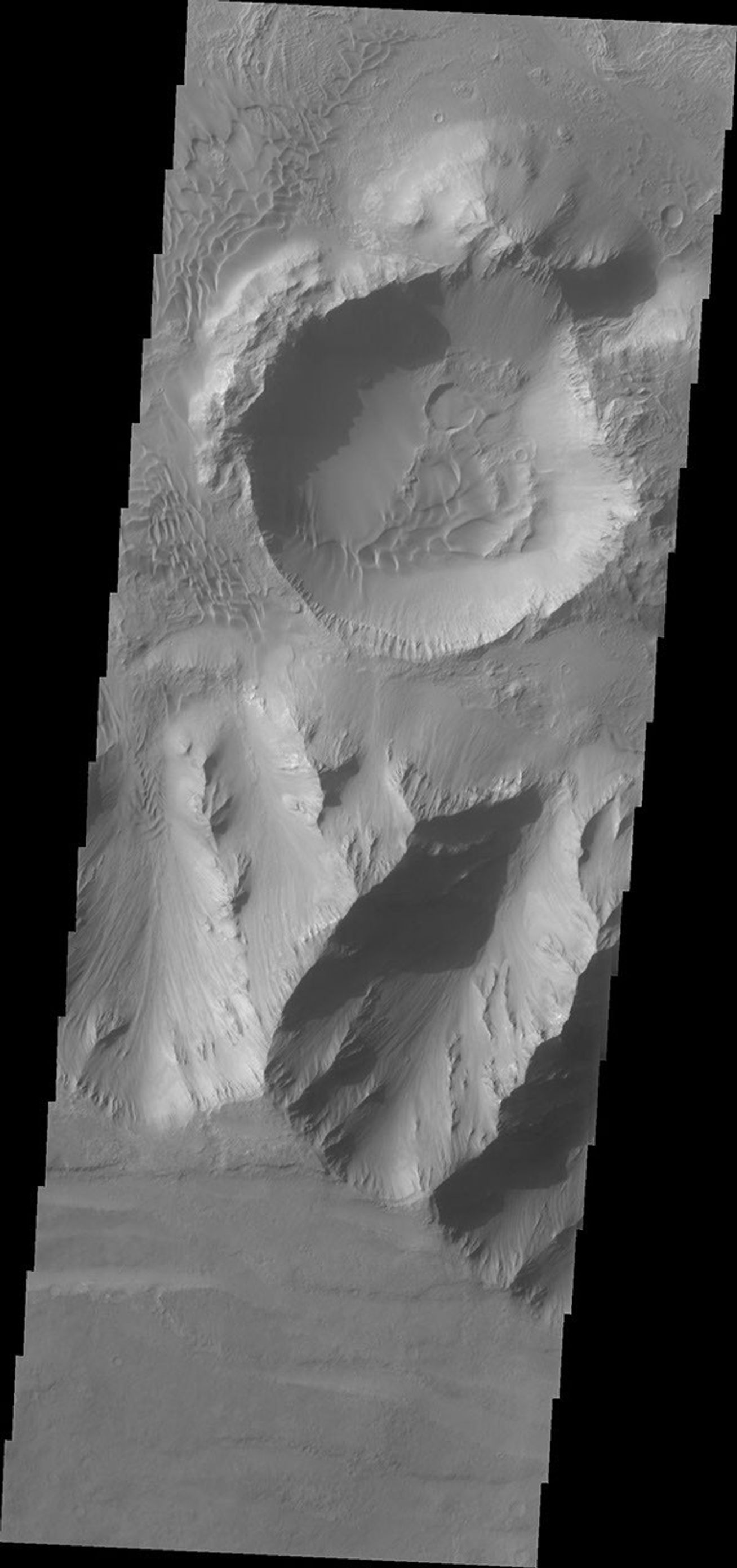 This view is located in eastern Coprates Chasma. The plateau above the chasma is visible in this image from NASA's 2001 Mars Odyssey spacecraft. The cliff face is very steep, with the elevation dropping over 3 miles from the plateau to the canyon floor.