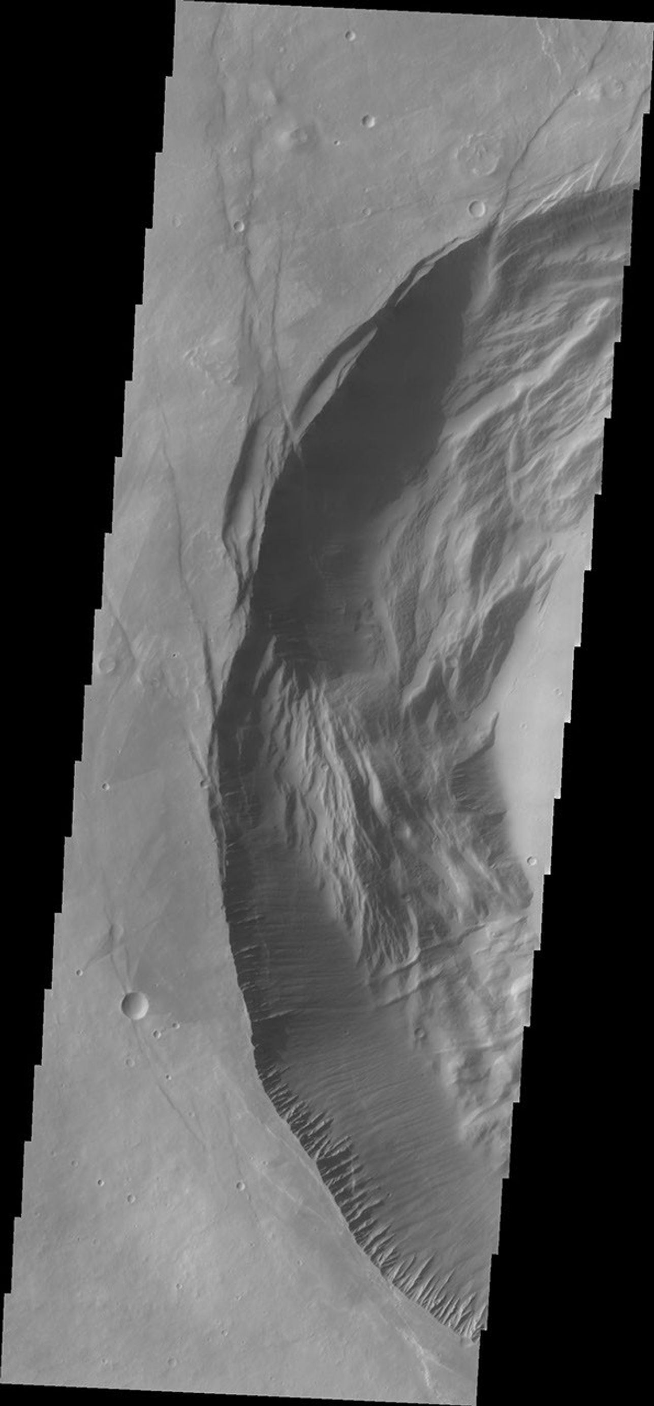 This image from NASA's 2001 Mars Odyssey spacecraft shows the western part of the smaller summit caldera on Pavonis Mons. Pavonis Mons is one of the three aligned Tharsis Volcanoes.