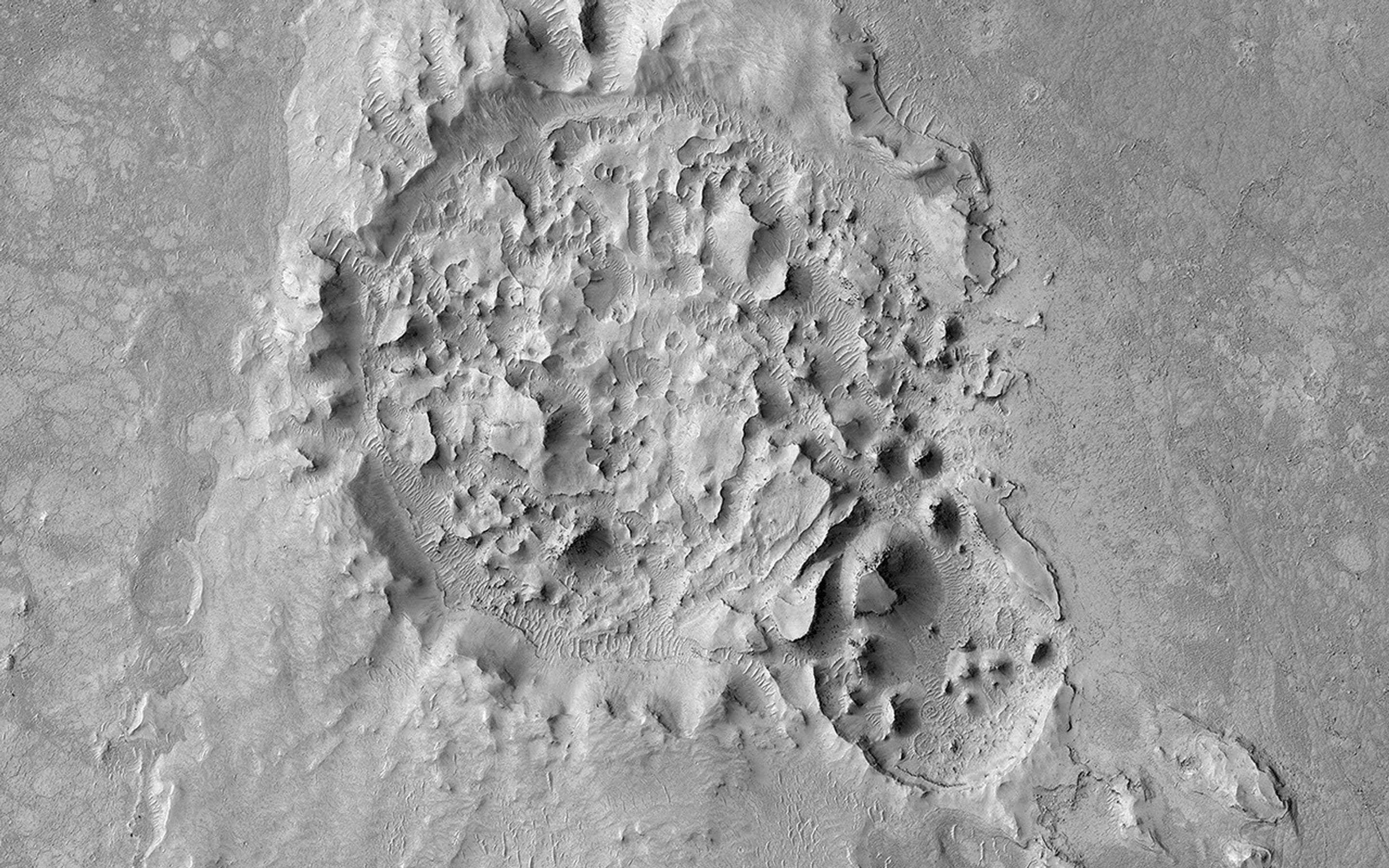 This image from NASA's Mars Reconnaissance Orbiter shows a crater is located in Elysium Planitia, Mars, an area dominated by volcanic processes. It is likely that the crater fill material is volcanic in origin.