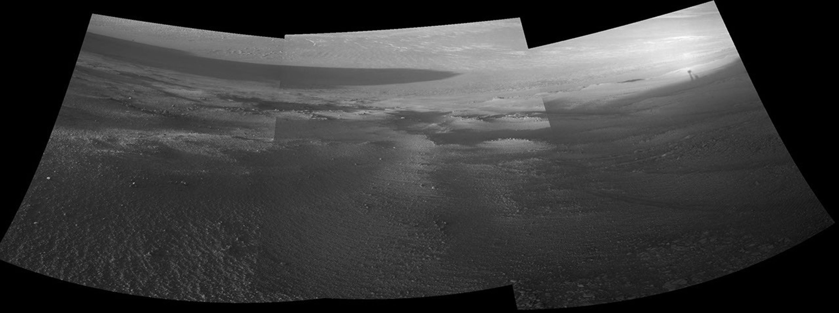 Late-afternoon shadows include one cast by the rover itself in this look toward the floor of Endeavour Crater by NASA's Mars Exploration Rover Opportunity. The rover recorded this scene on Nov. 11, 2017.