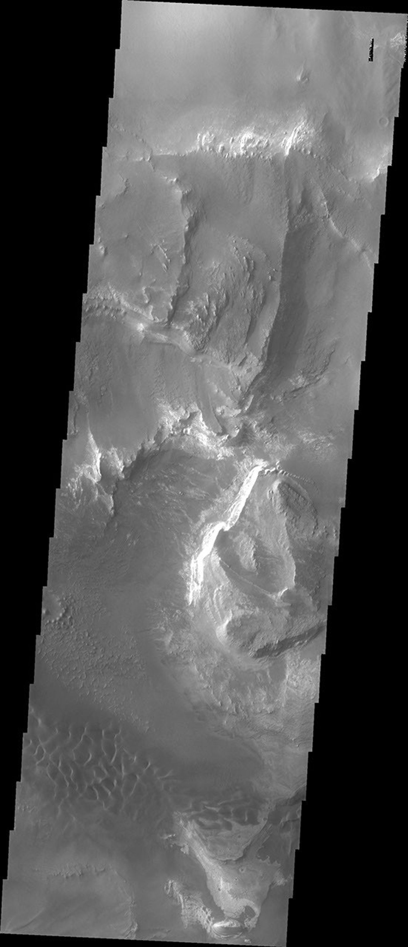 Melas Chasma is part of the largest canyon system on Mars, Valles Marineris. This image from NASA's 2001 Mars Odyssey spacecraft shows layered materials and sand dunes.