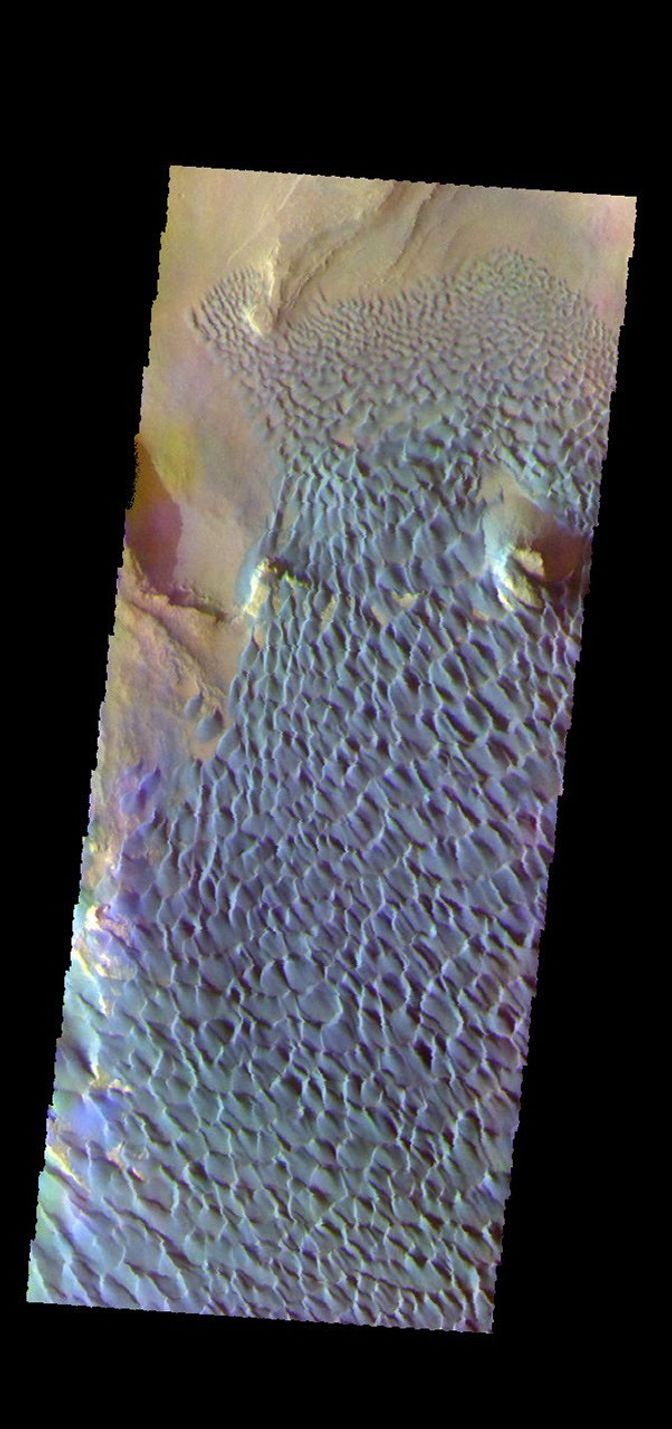 This is a false color image of Rabe Crater captured by NASA's 2001 Mars Odyssey spacecraft. In this combination of filters 'blue' typically means basaltic sand. Rabe Crater is 108 km (67 miles) across.