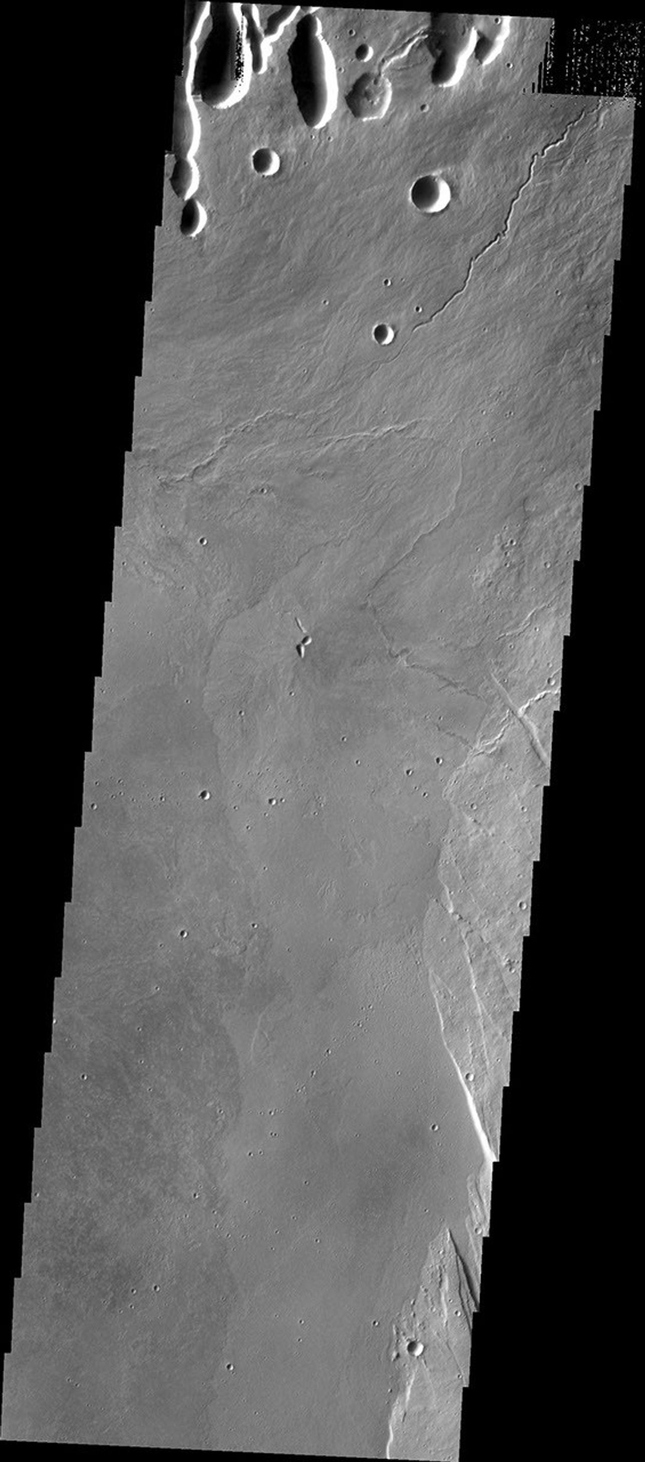 This image from NASA's 2001 Mars Odyssey spacecraft shows part of the caldera floor of Arsia Mons. Arsia Mons is the southernmost of the Tharsis volcanoes. It is 270 miles in diameter, almost 12 miles high, and the summit caldera is 72 miles wide.