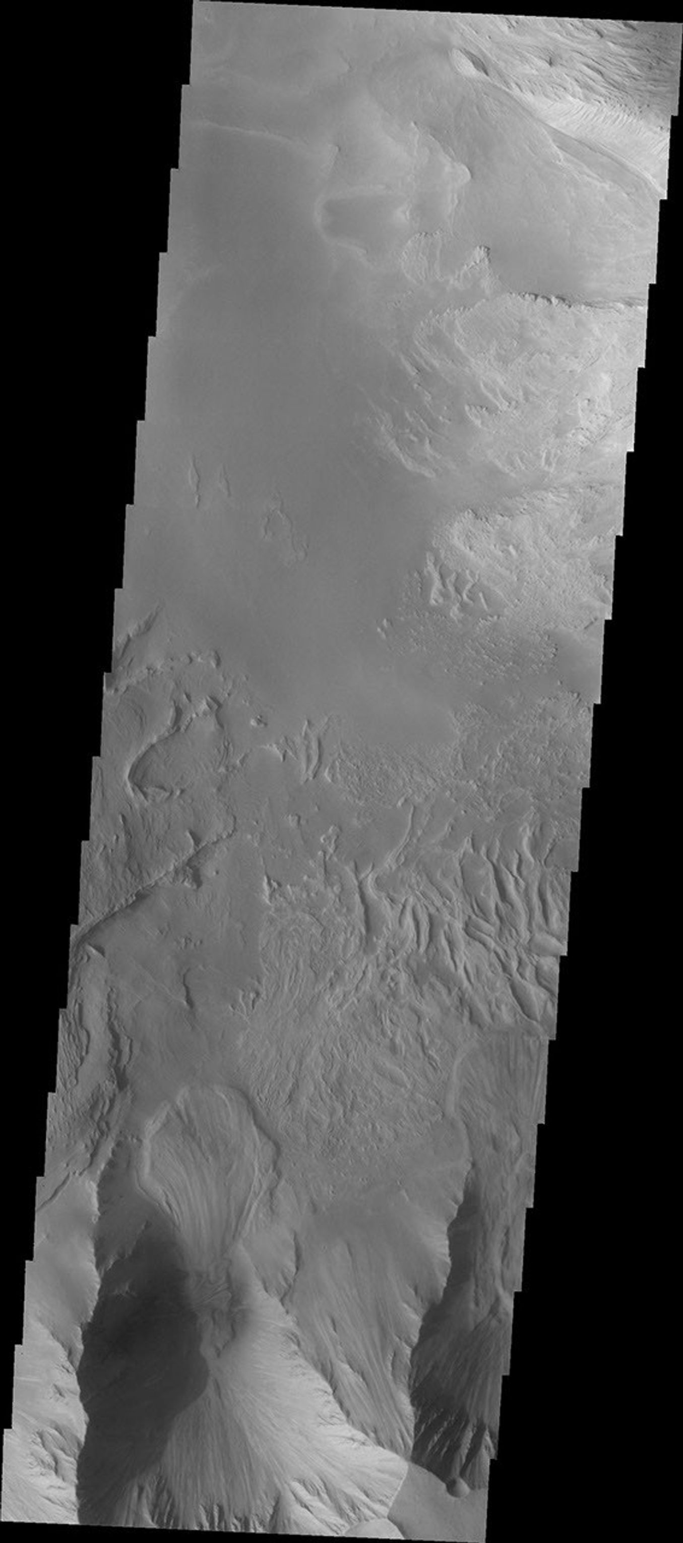 This image from NASA's 2001 Mars Odyssey spacecraft shows part of eastern Candor Chasma. At the bottom of the image is the steep cliff between the upper surface elevation and the depths of Candor Chasma.